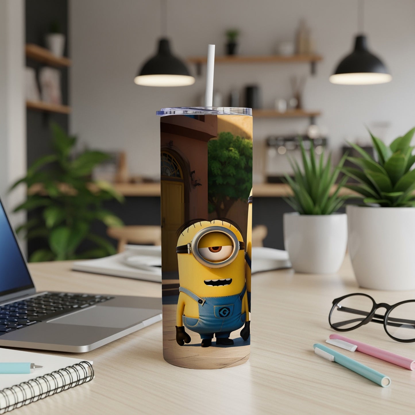 Minions character on a tall tumbler with a straw, on a wooden desk.