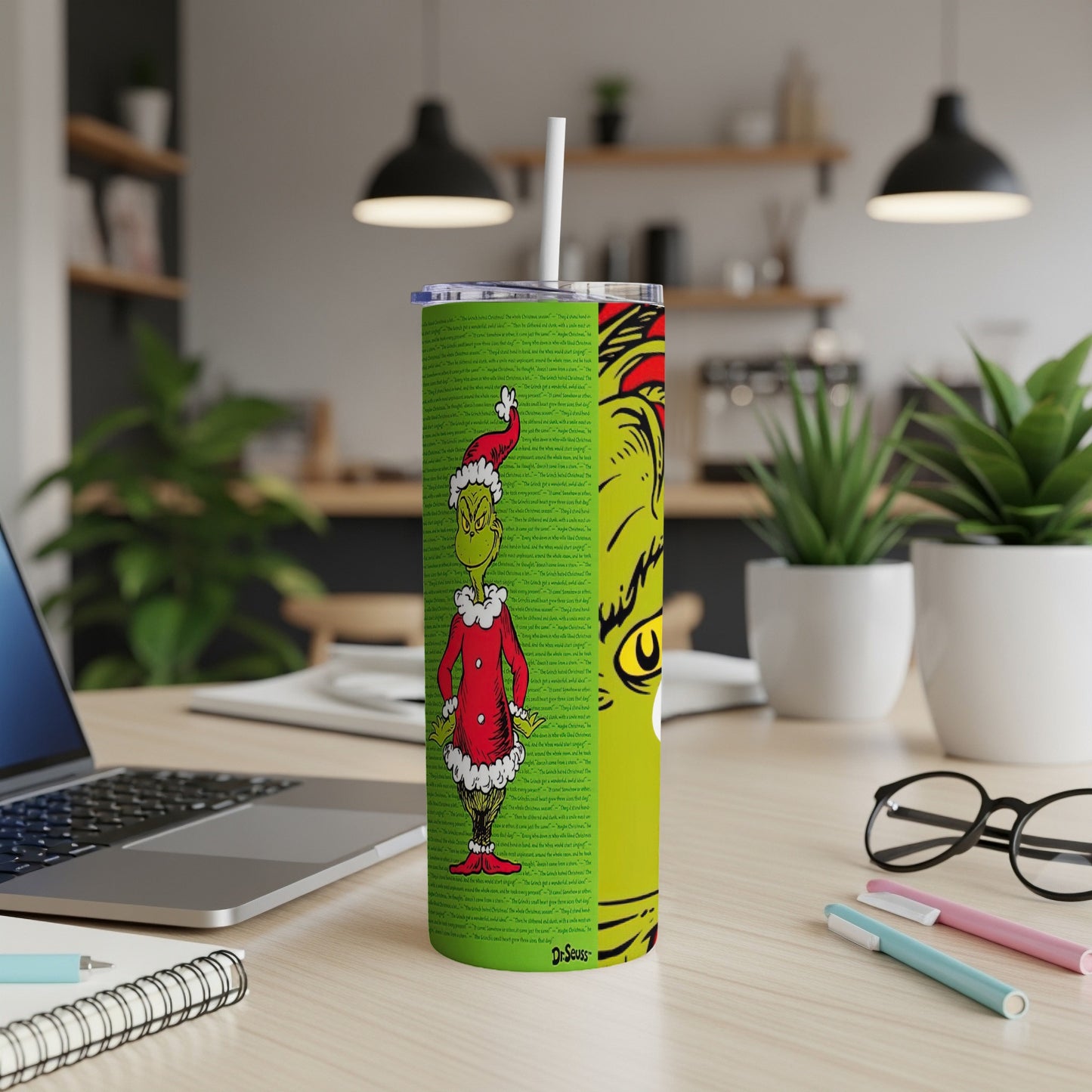 Green tumbler with The Grinch quotes and illustrations.