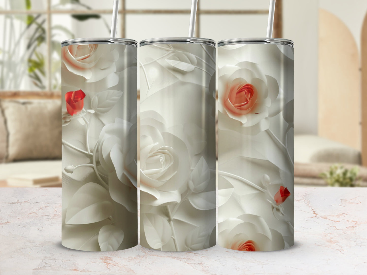 Three tumblers with cream roses and red accents on a marble surface.