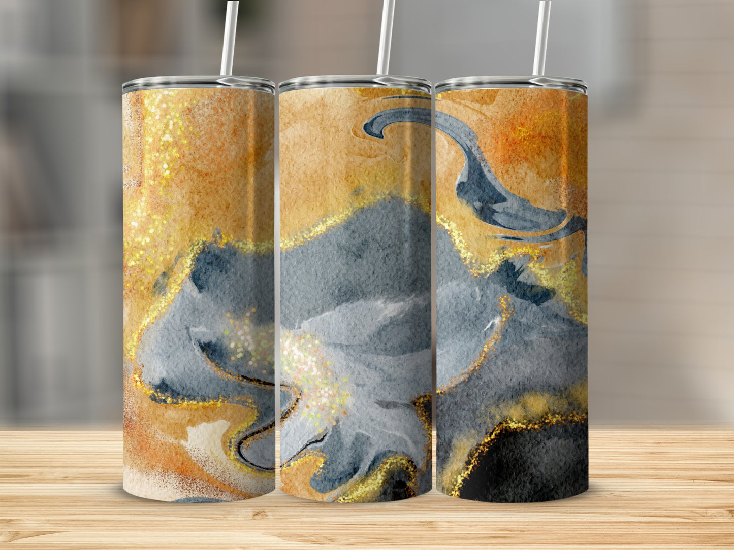 Three tumblers with abstract gold, gray, and black watercolor and glitter design.