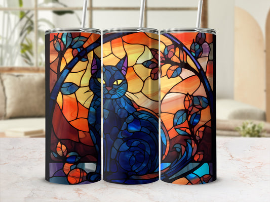 Blue cat against a stained glass window with branches and leaves.