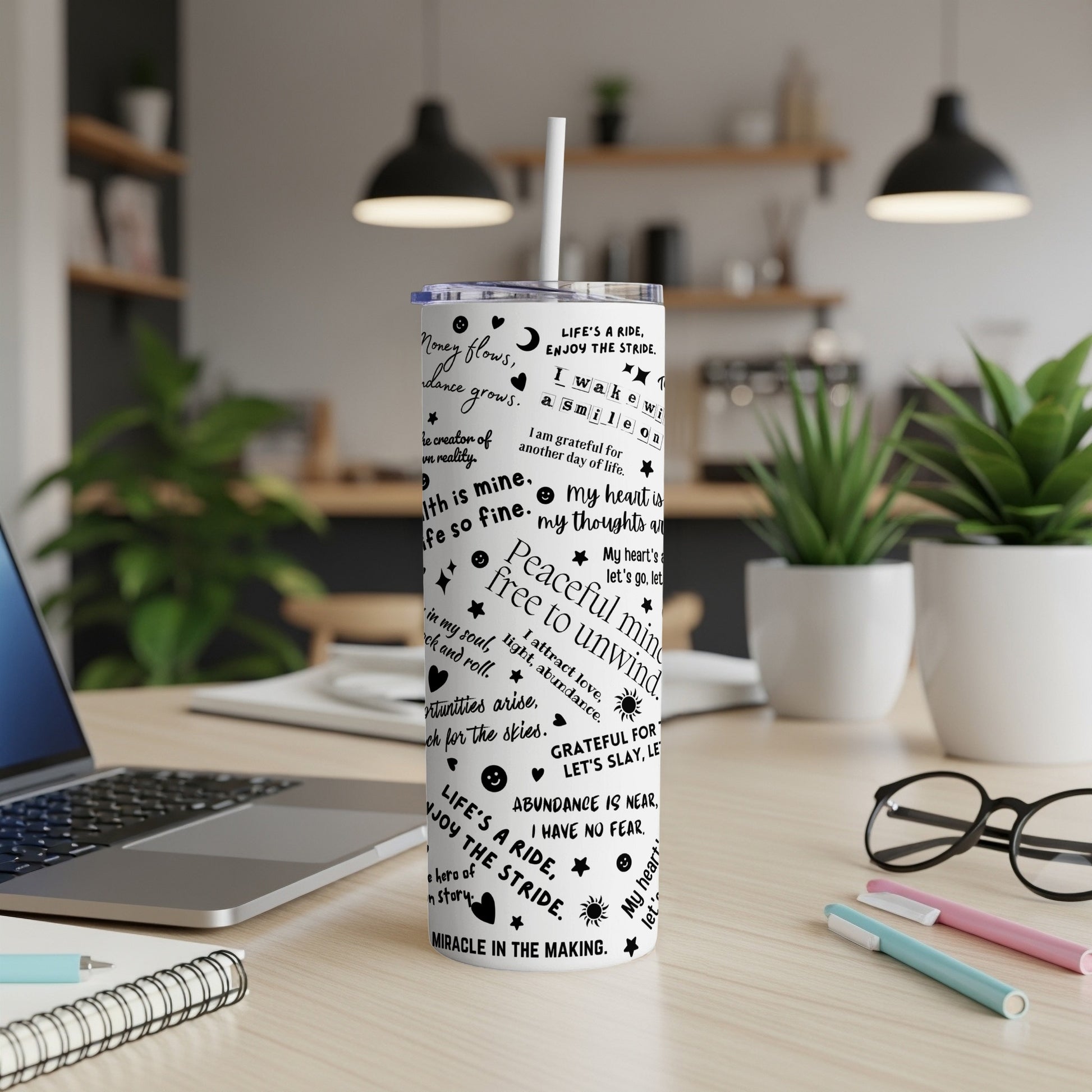 Tumbler with inspirational quotes and abstract patterns in black and white.