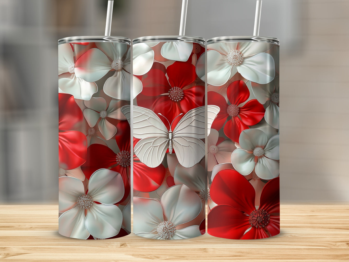 Three tumblers with red and white flowers and a butterfly design.