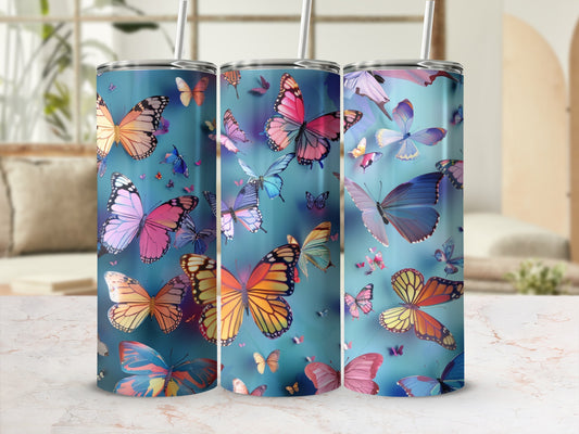 Three tumblers with colorful butterflies against a blue background.