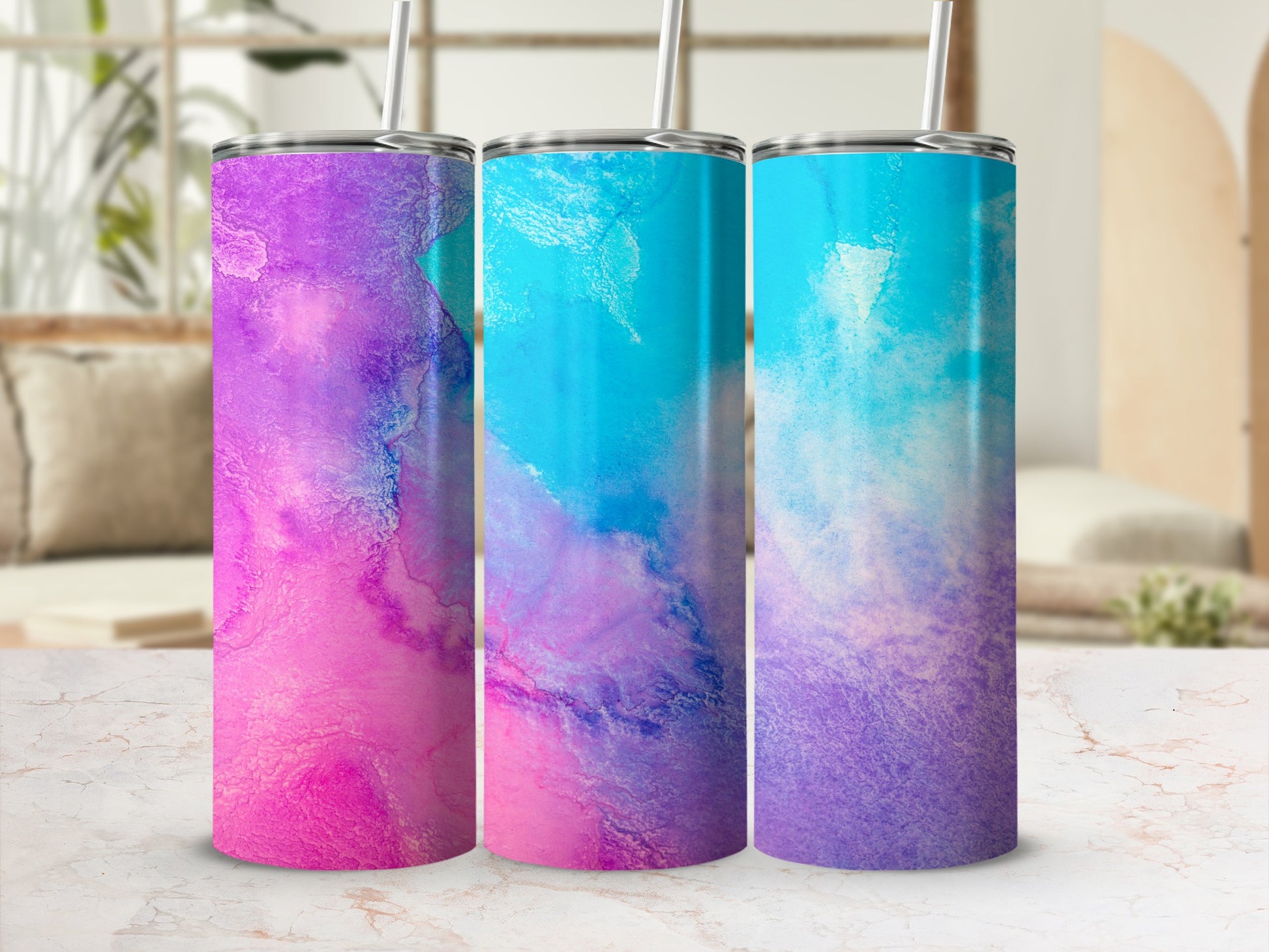 Three tumblers with a pink, purple, and blue watercolor design.
