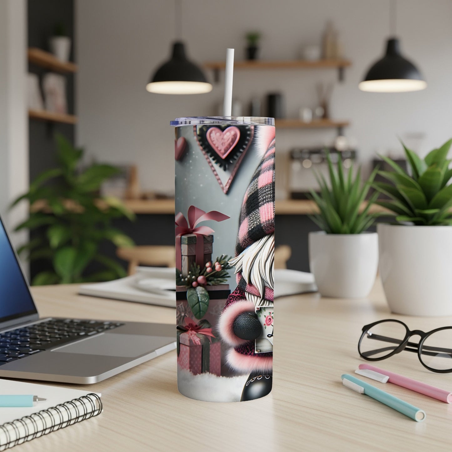 Gnome tumbler with pink hearts and presents on a desk.