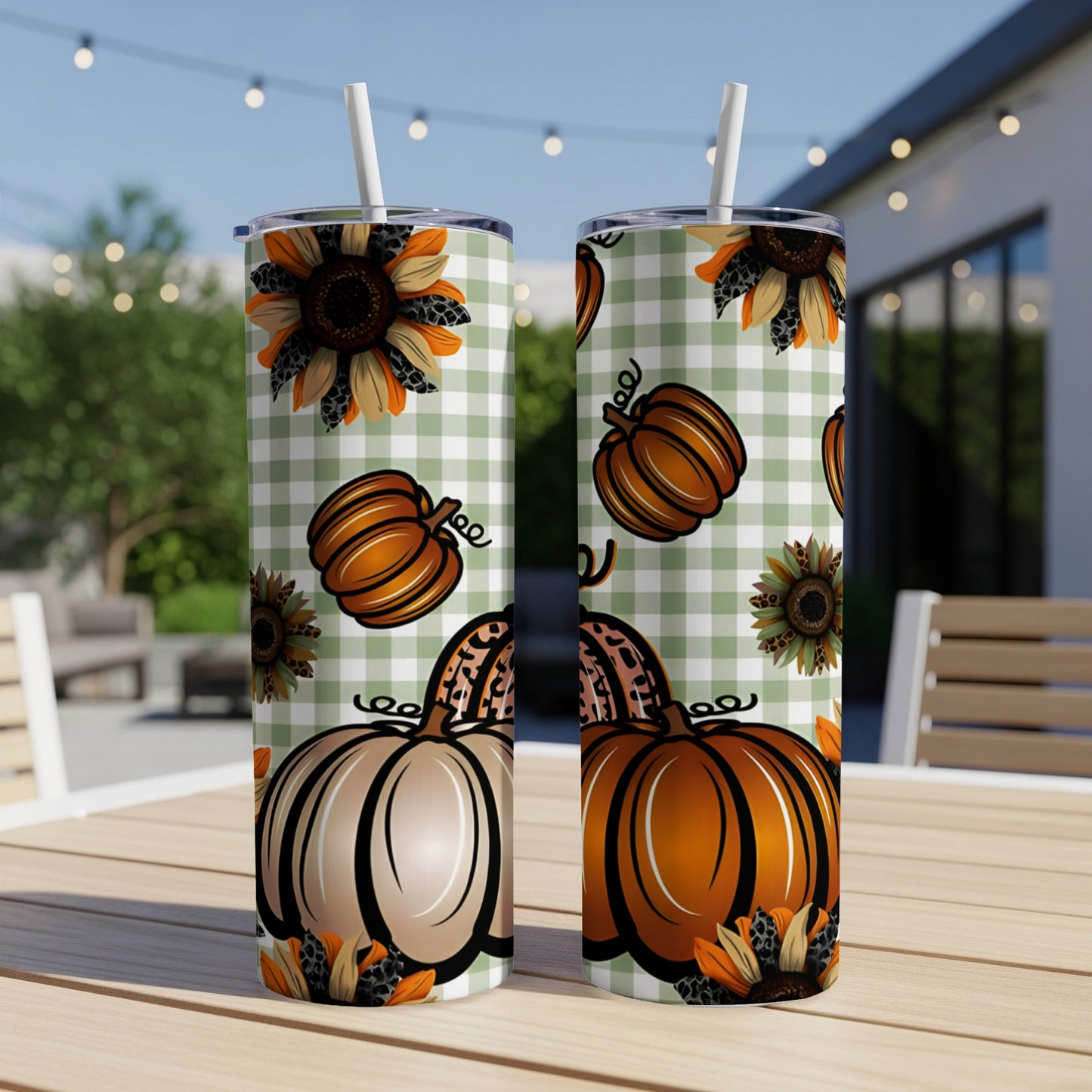 Two tumblers with pumpkins and sunflowers on a green gingham pattern.