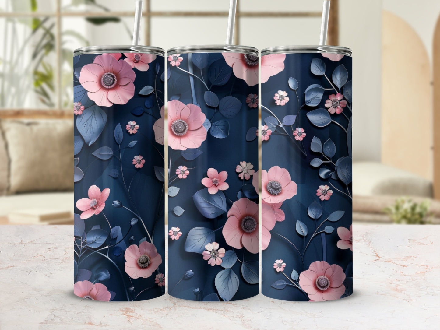 Three navy blue tumblers with pink floral and leaf pattern.