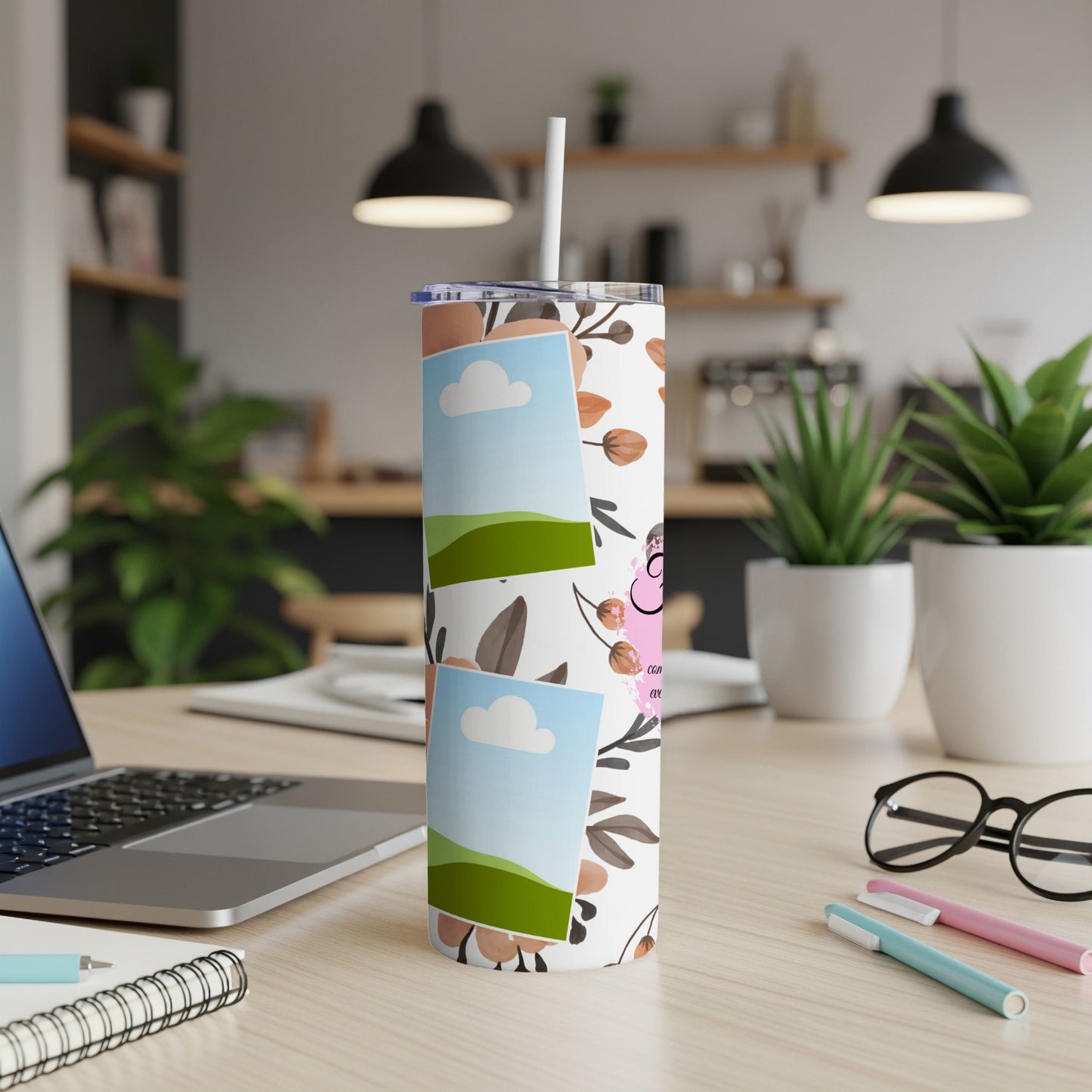 Tumbler with floral pattern and photo placeholders on desk with laptop and glasses.