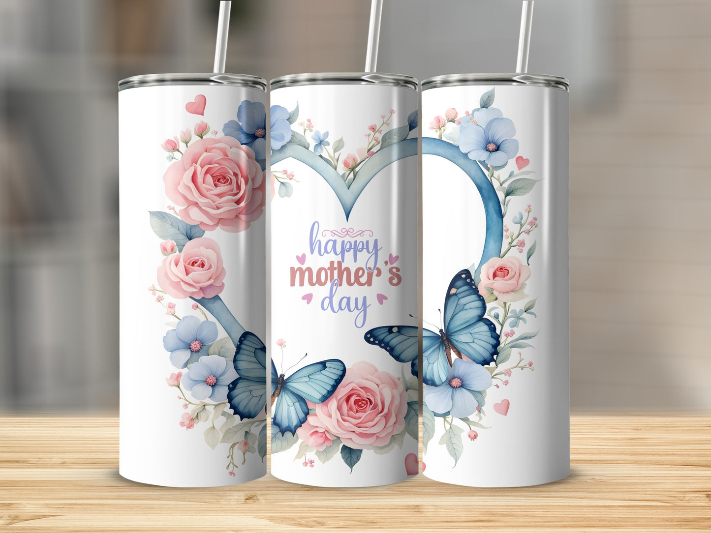 Pink and blue floral heart with butterflies and "Happy Mother's Day" text on tumblers.