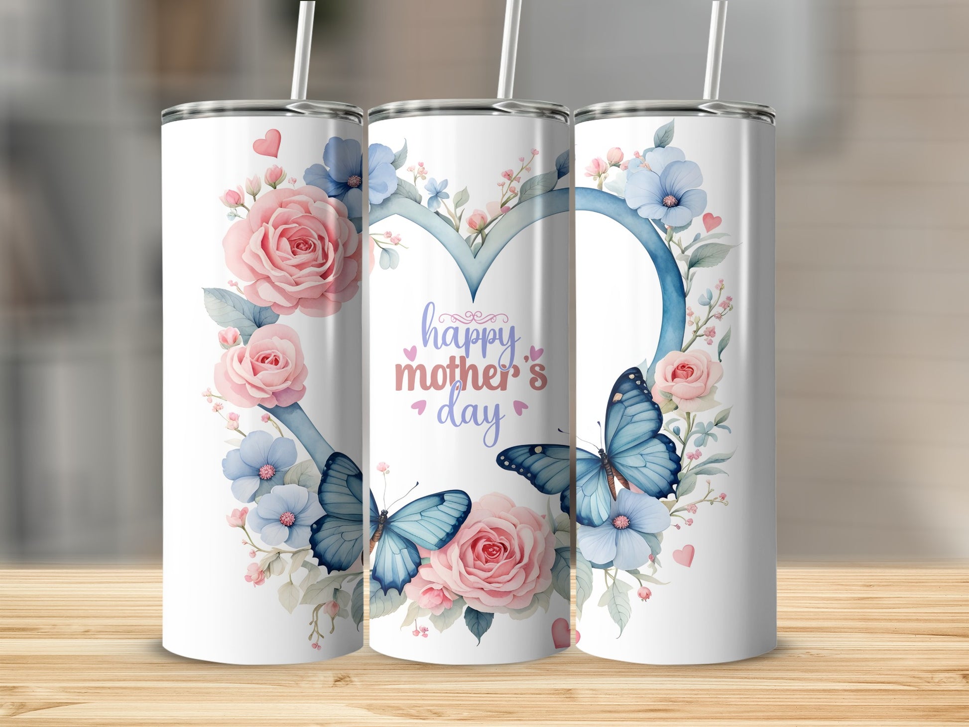 Pink and blue floral heart with butterflies and "Happy Mother's Day" text on tumblers.