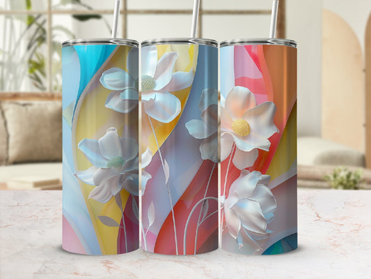 Three tumblers with pastel floral designs sit on a surface.