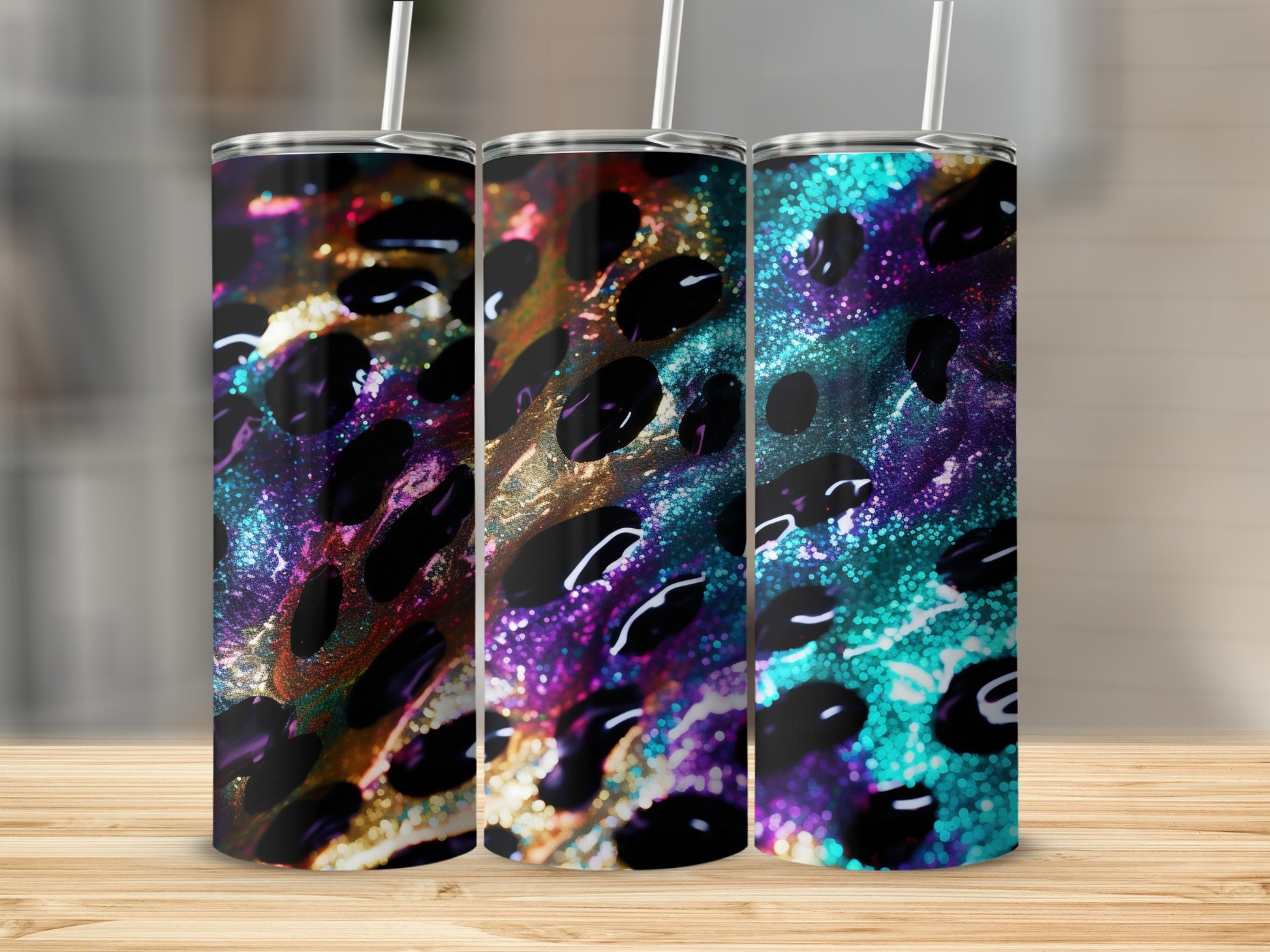 Three tumblers with a colorful, abstract leopard print design and straw.