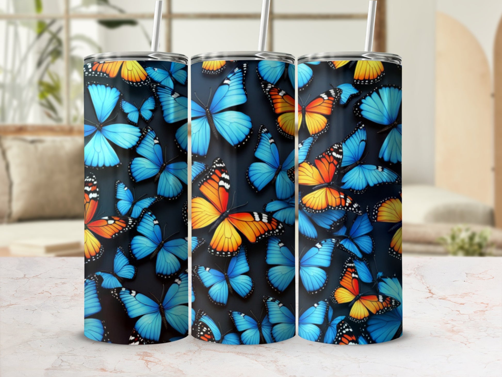 Three tumblers featuring a blue and orange butterfly pattern.