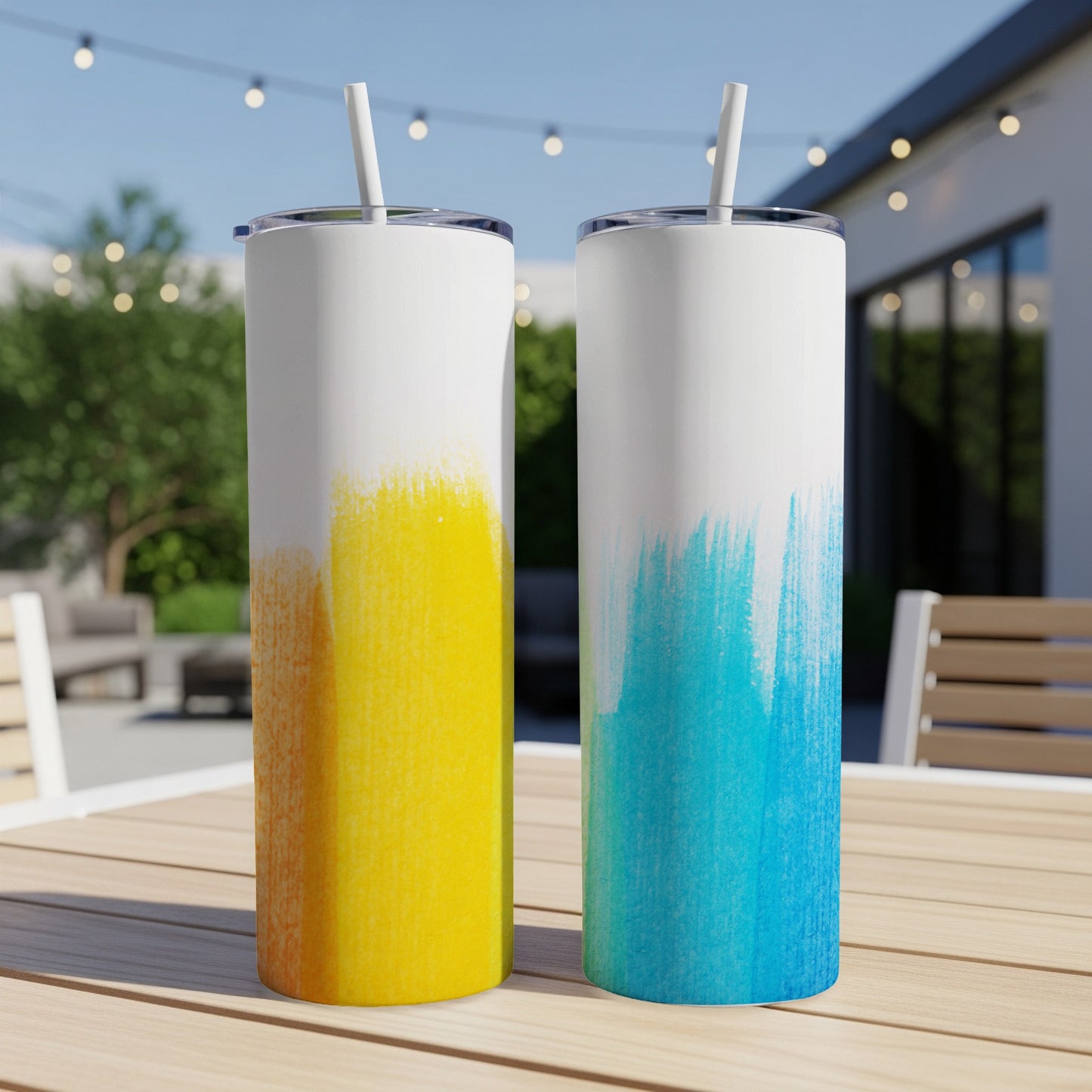 Two white tumblers with yellow and blue brushstroke designs.