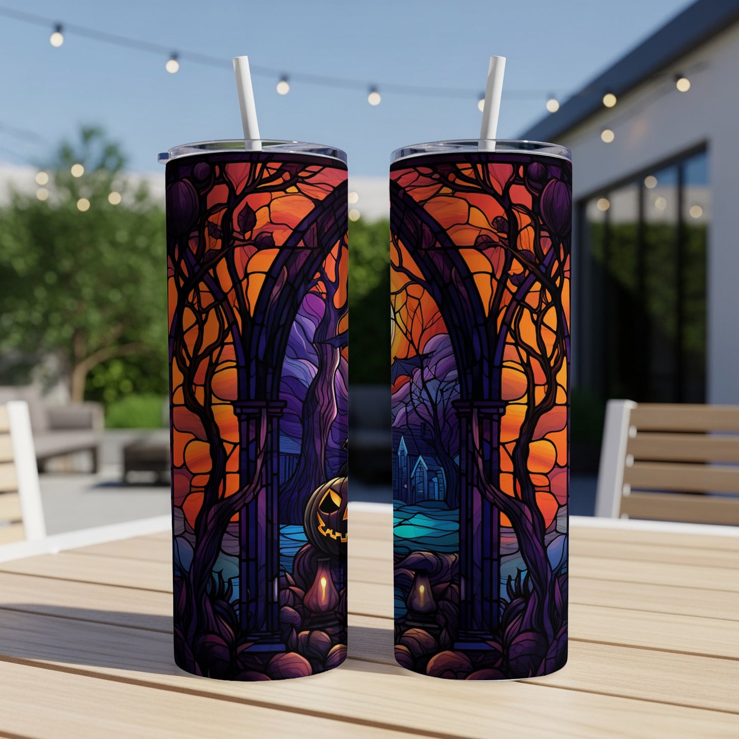 Two tumblers with a spooky Halloween scene featuring a pumpkin and arched gateway.