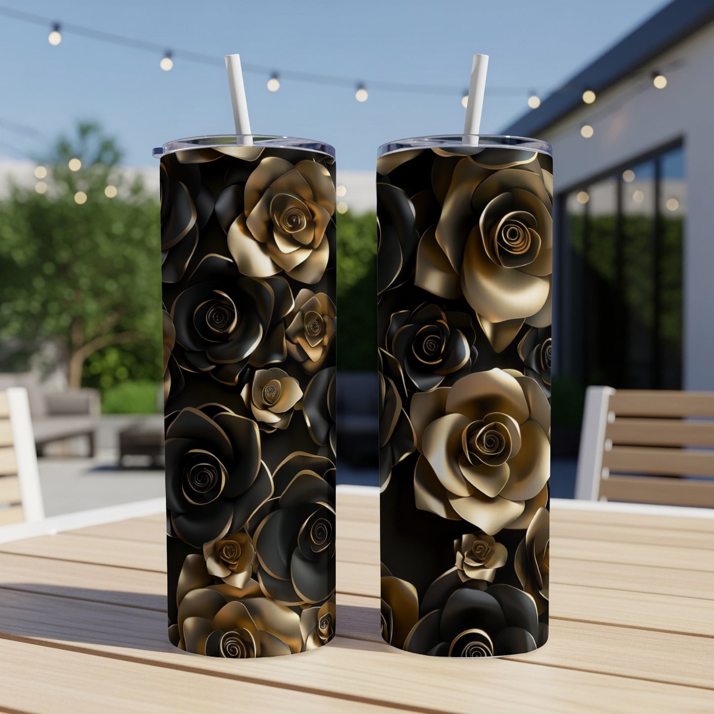 Two black tumblers with gold rose patterns sit on a table.