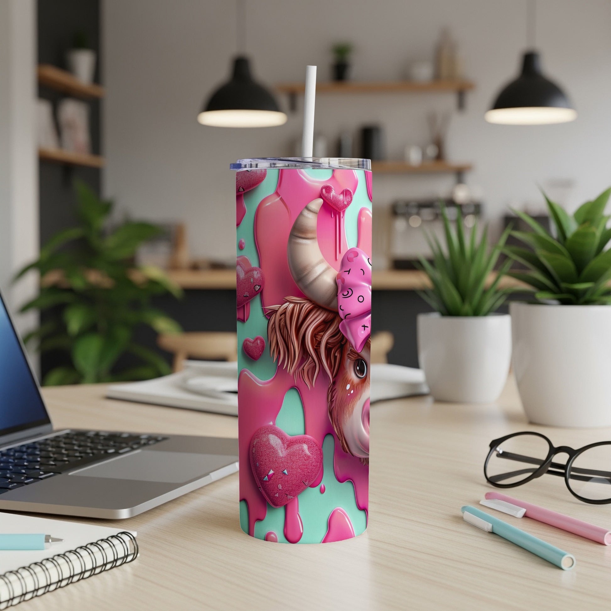 Pink and teal tumbler with cow print and heart details.