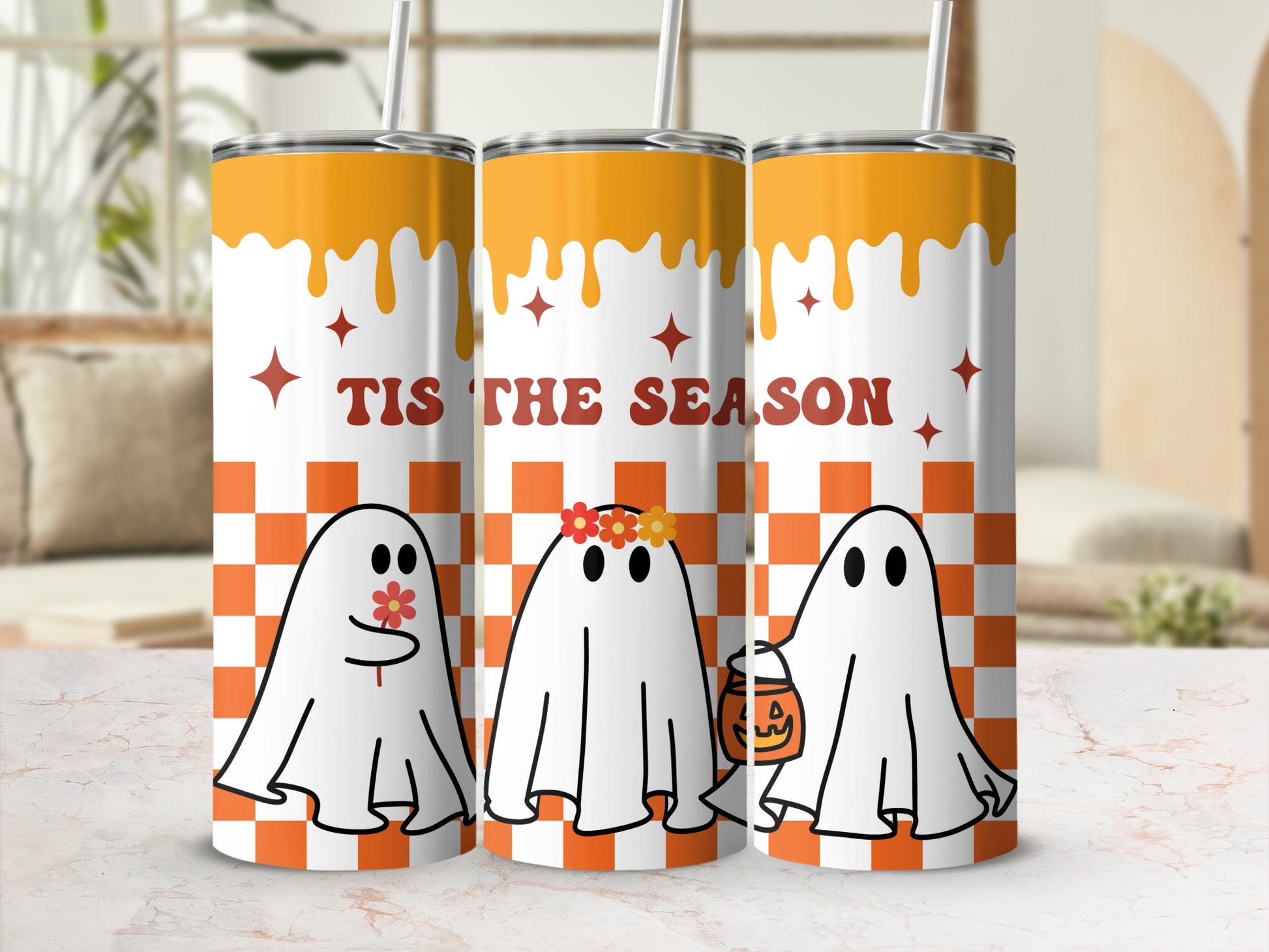 Three tumblers with ghosts and "Tis the Season" text against an orange checkerboard.