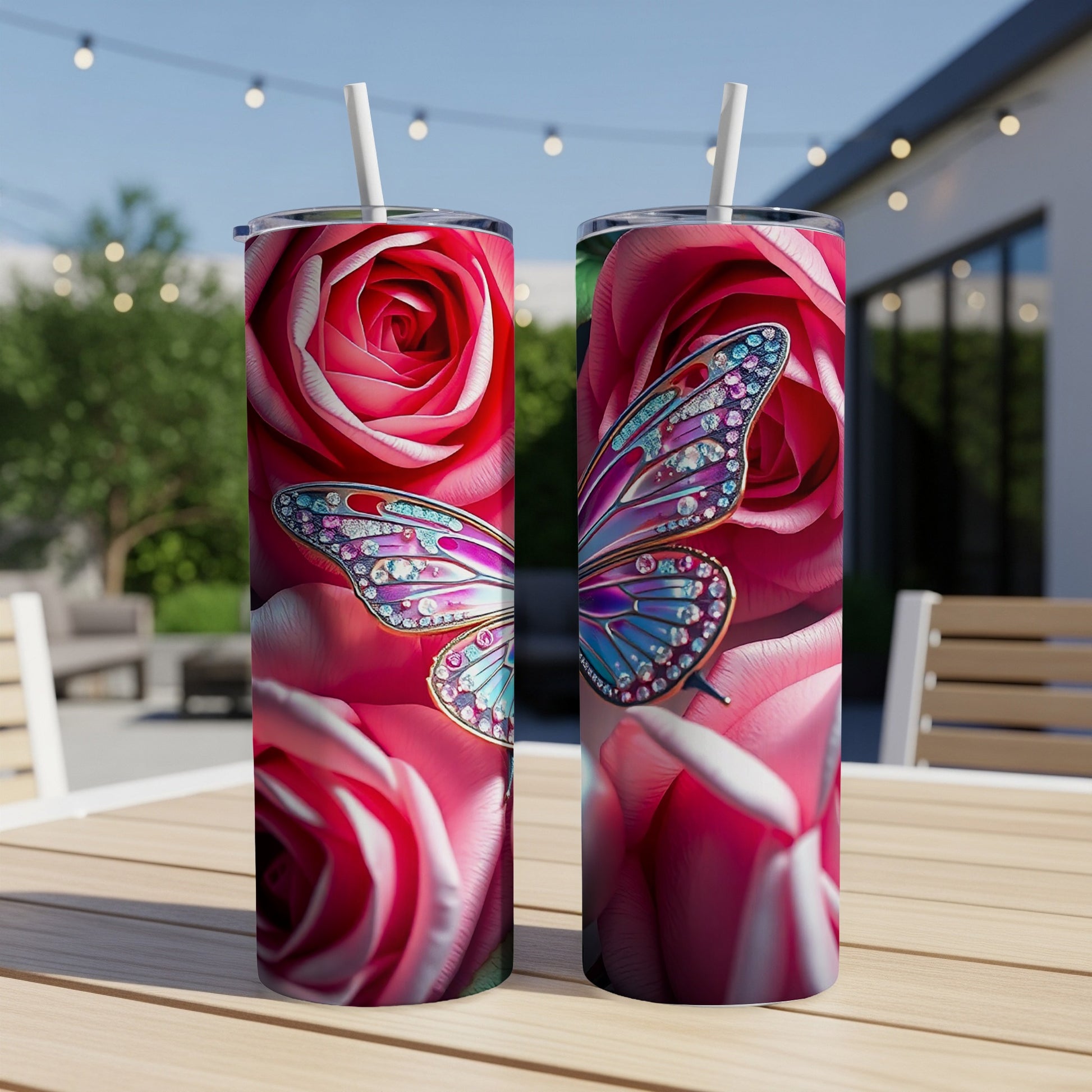 Two tumblers with pink roses and jeweled butterflies sit on a wooden table.