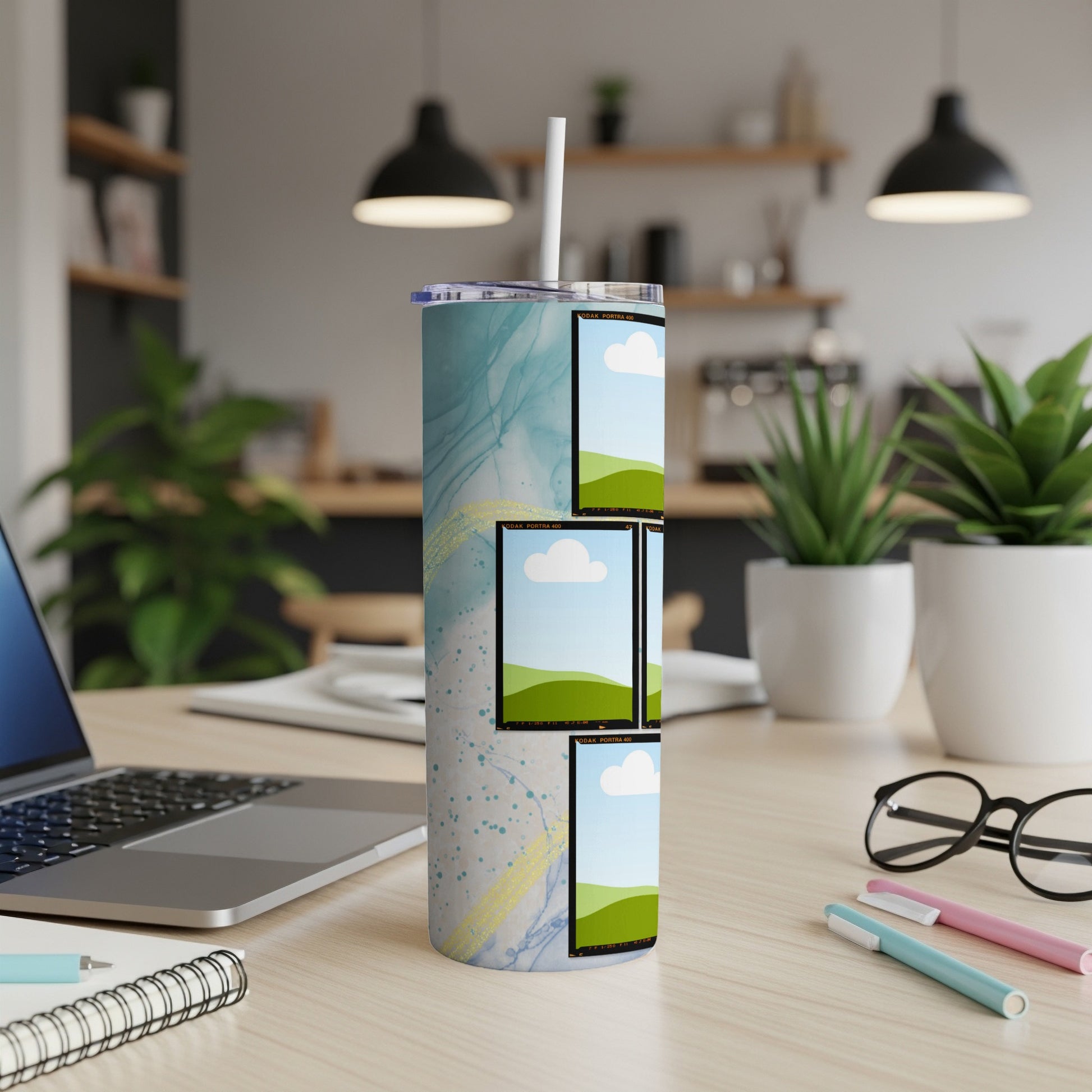 Tumbler with marbled blue and gold design featuring mock film strip photo placeholders.