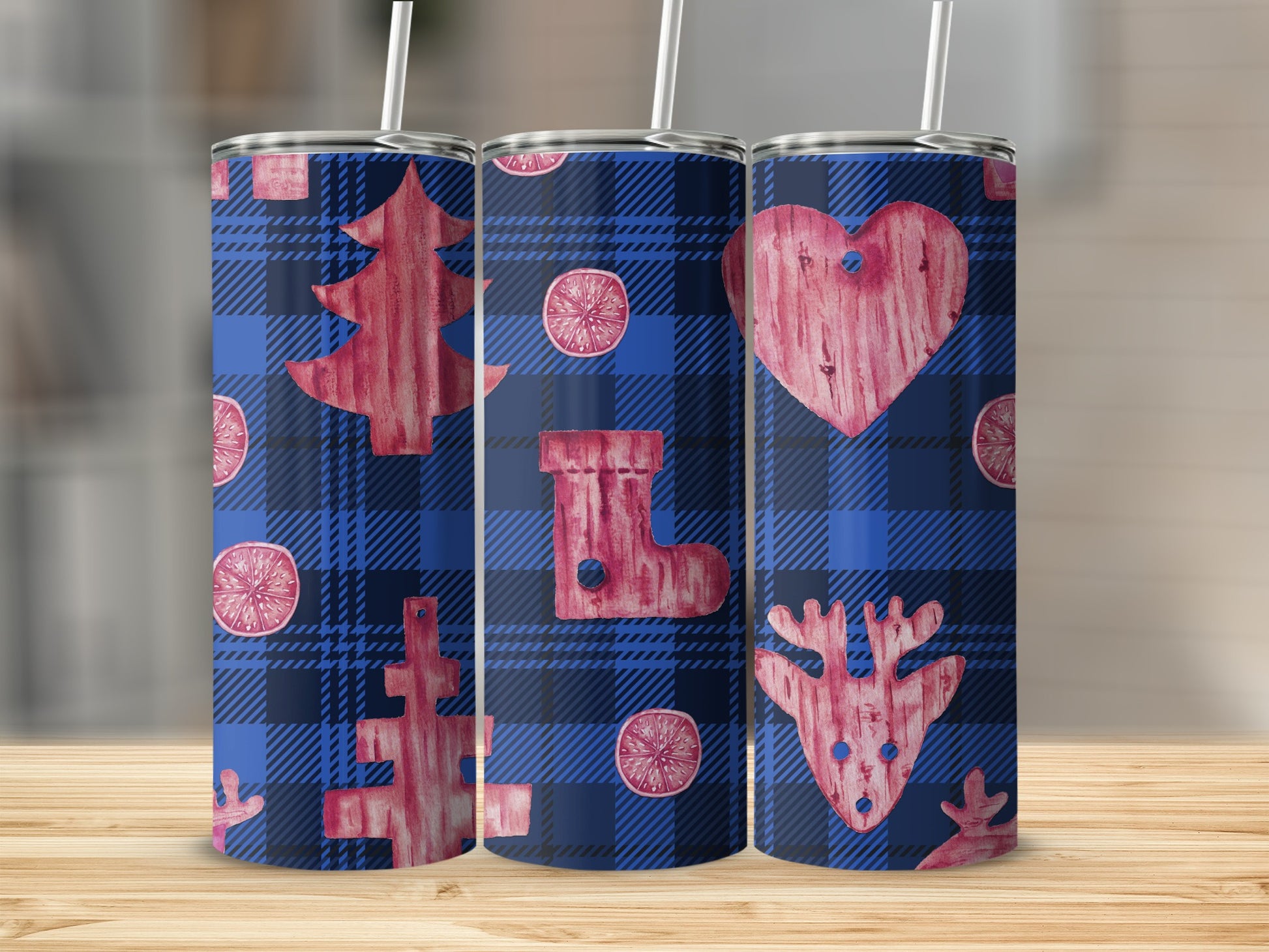 Three tumblers with blue plaid and red Christmas designs: tree, stocking, and reindeer.