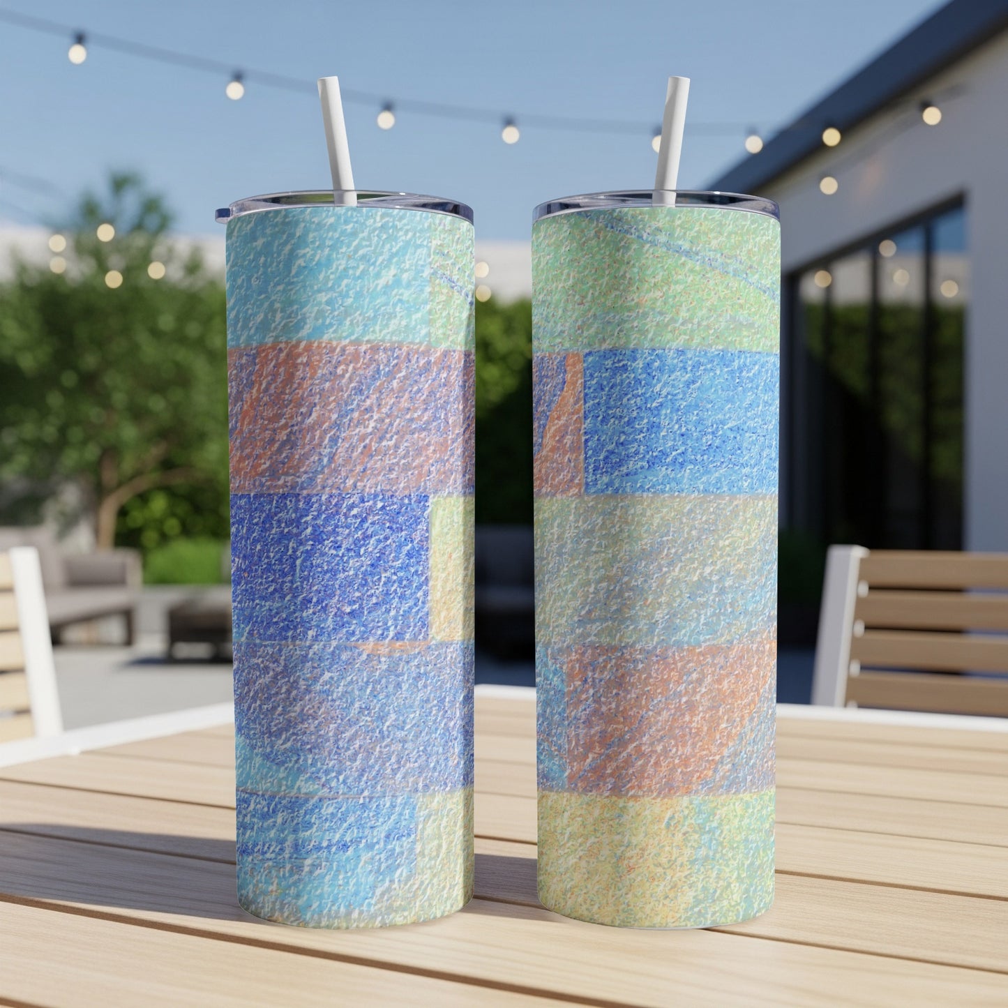 Two textured tumblers with a colorful abstract pattern on a wooden table.