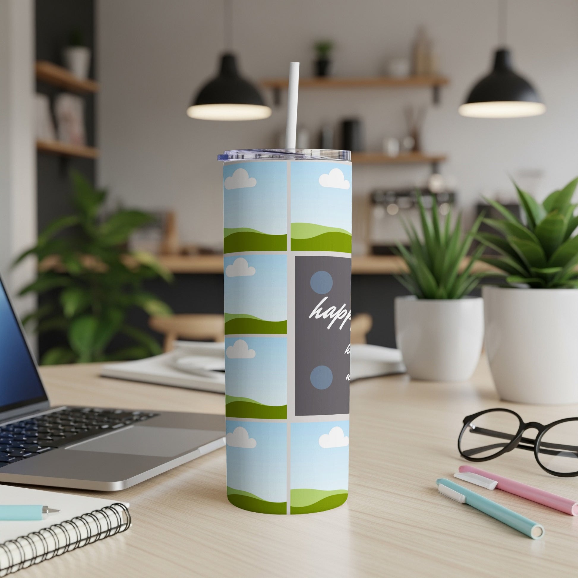 Tumbler with sky and hills design and "happy days" text.