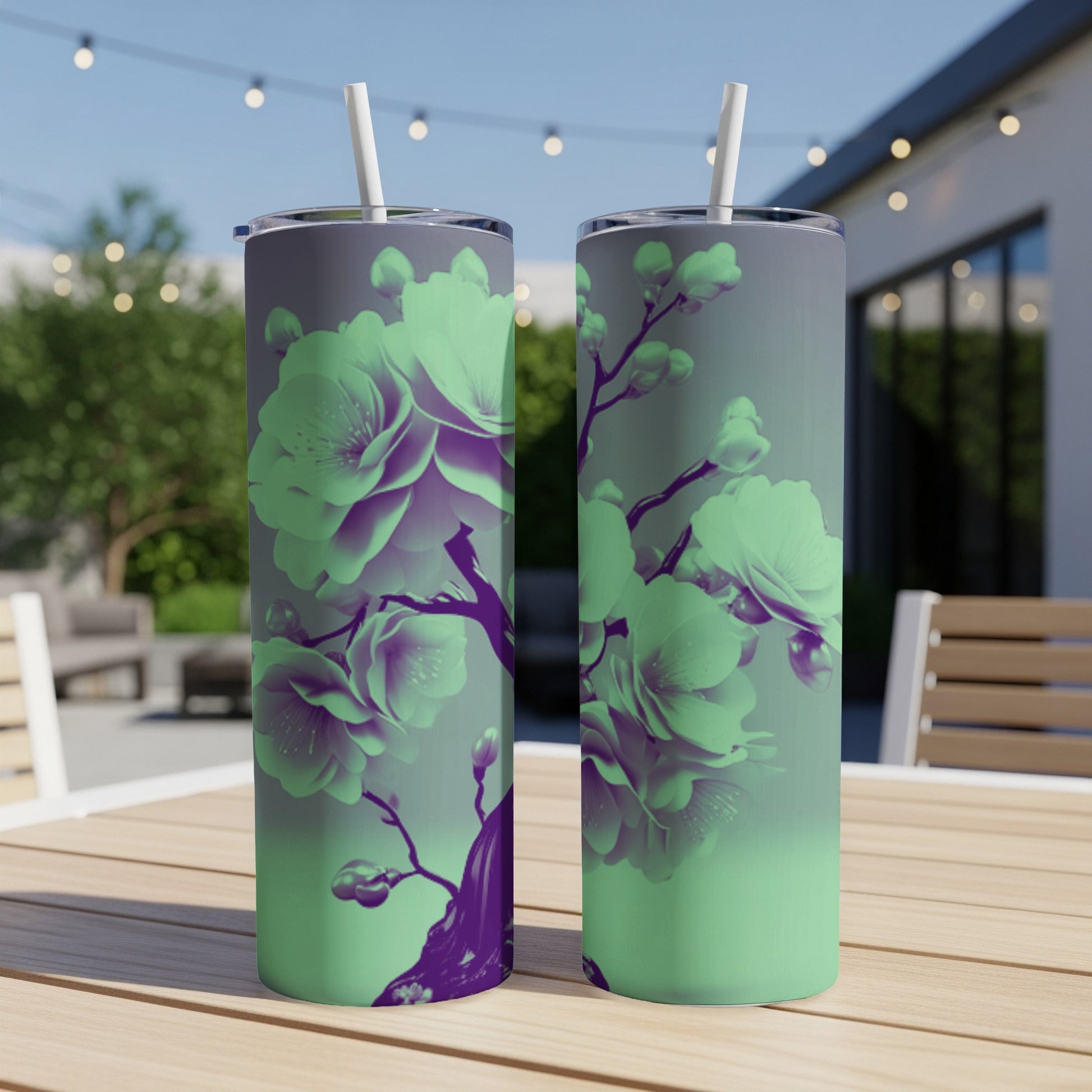 Two tumblers with a purple and green floral design sit on a table.
