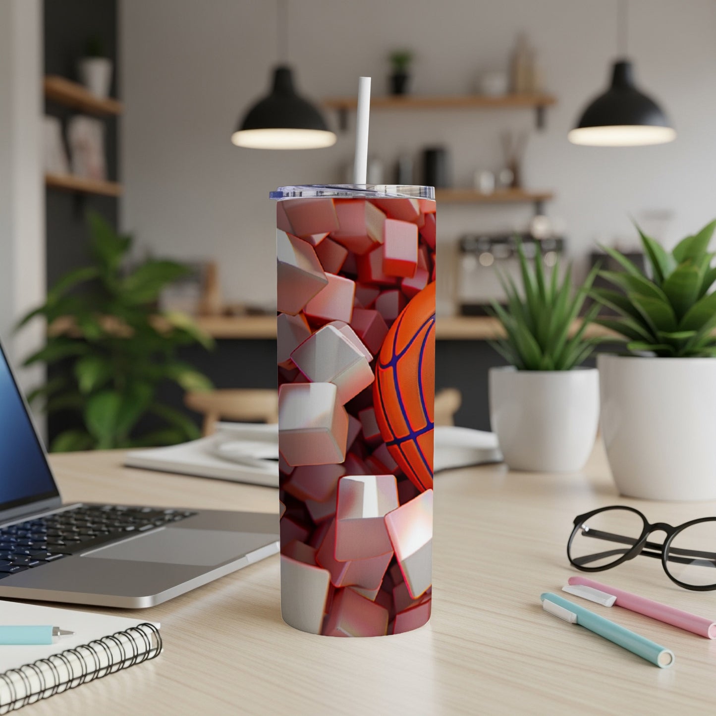 Basketball pattern tumbler with a straw on a desk.