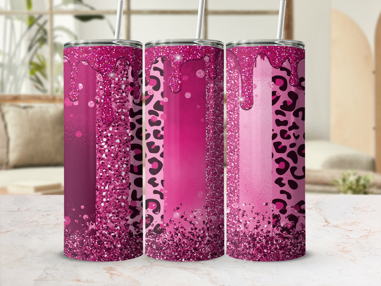 Pink glitter and leopard print pattern on three tumblers with straws.