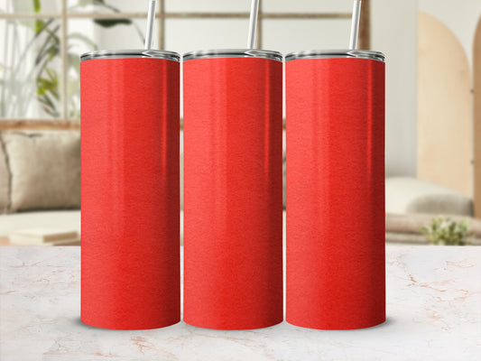 Three red tumblers with straws on a marble countertop, with a blurred background.
