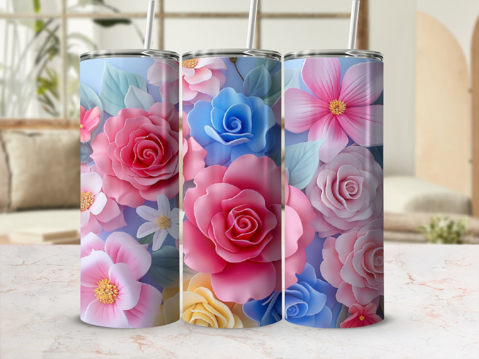 Three tumblers with vibrant pink and blue floral designs.