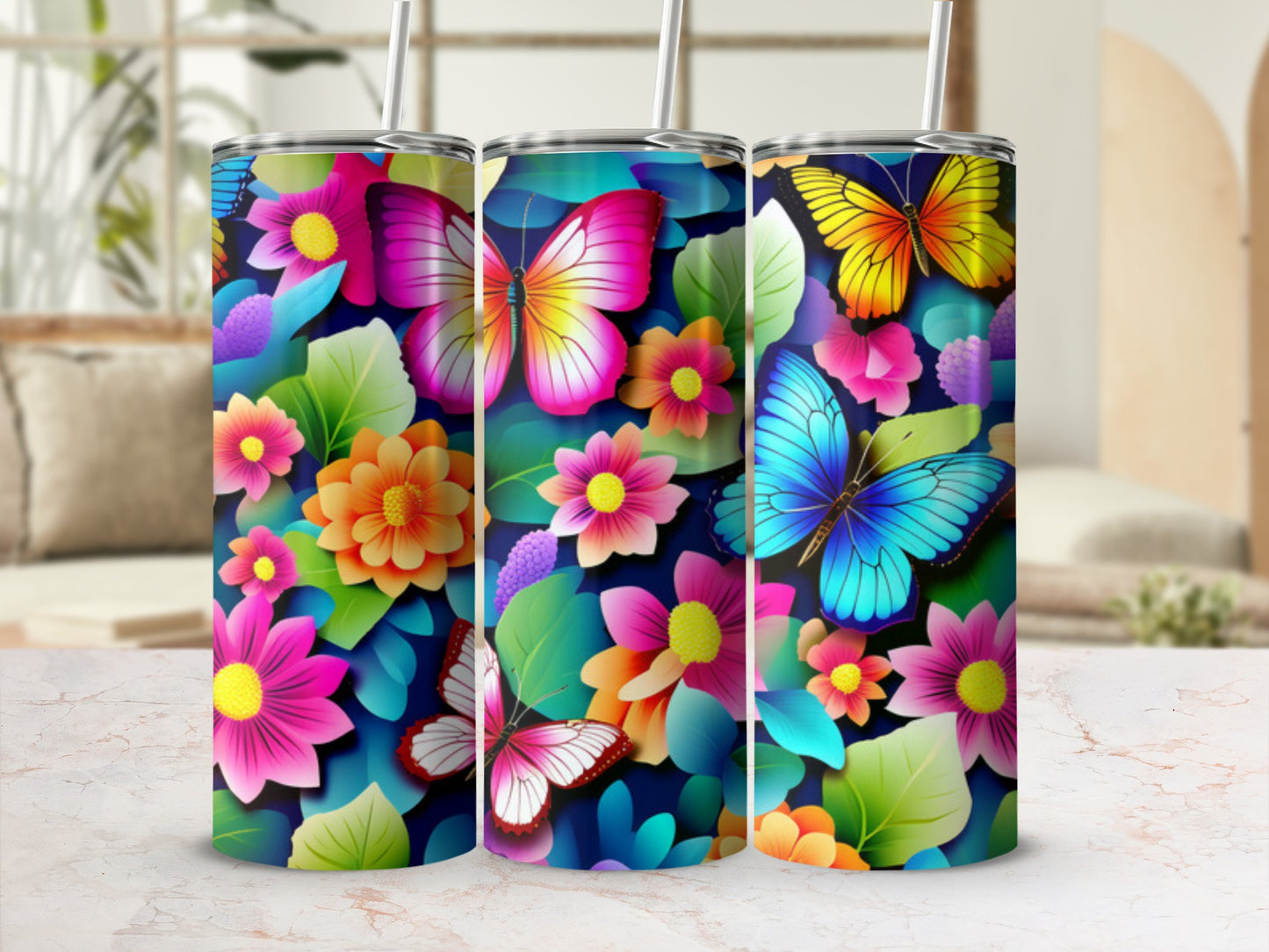 Three tumblers with colorful butterflies and floral designs.