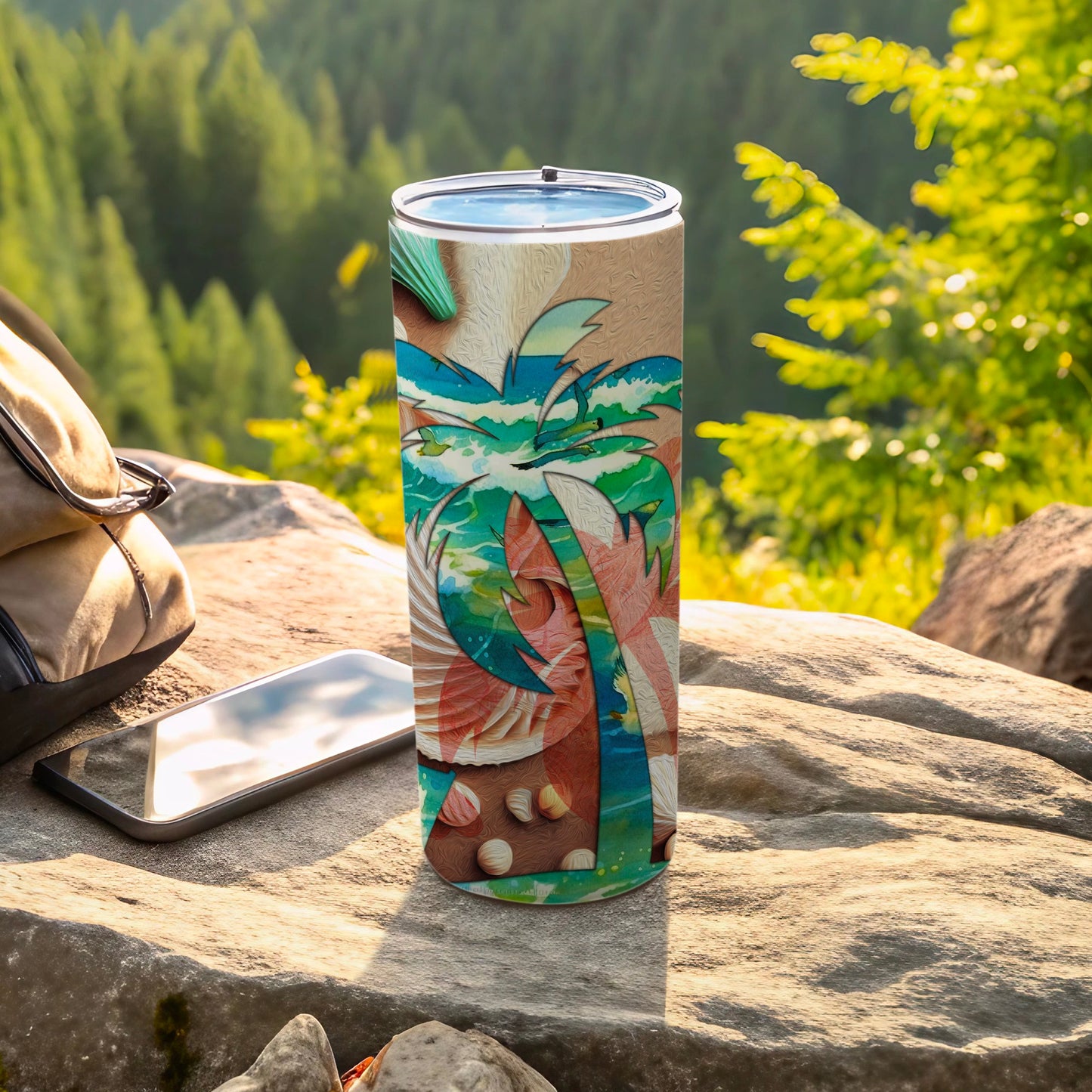 Palm tree and seashell design on a stainless steel tumbler with phone and backpack.