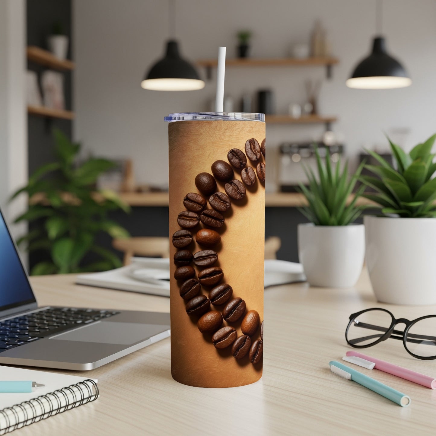 Tumbler with coffee beans arranged in a circular pattern.
