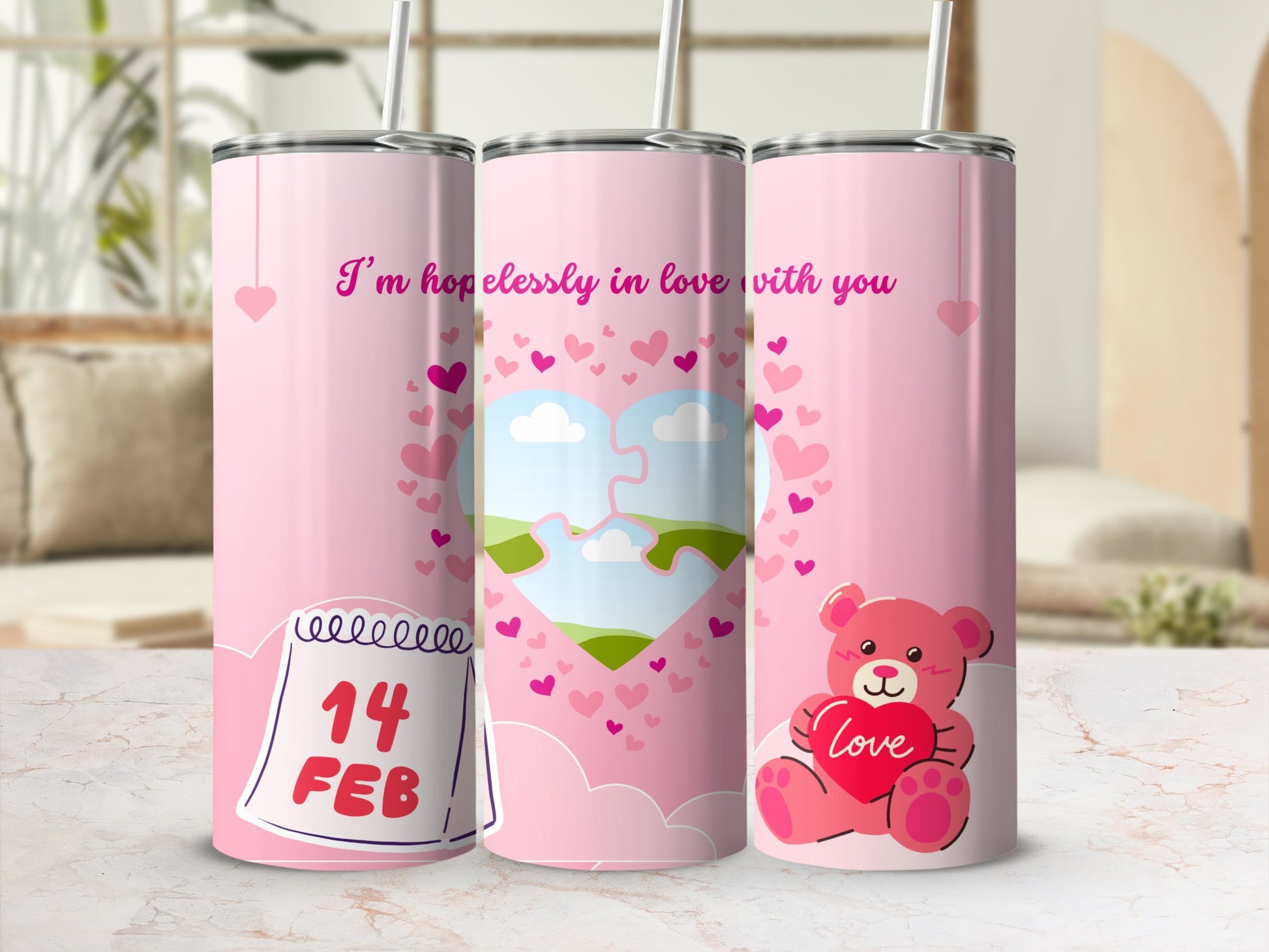 Three pink tumblers with Valentine's Day designs, including a calendar, puzzle heart, and teddy bear.