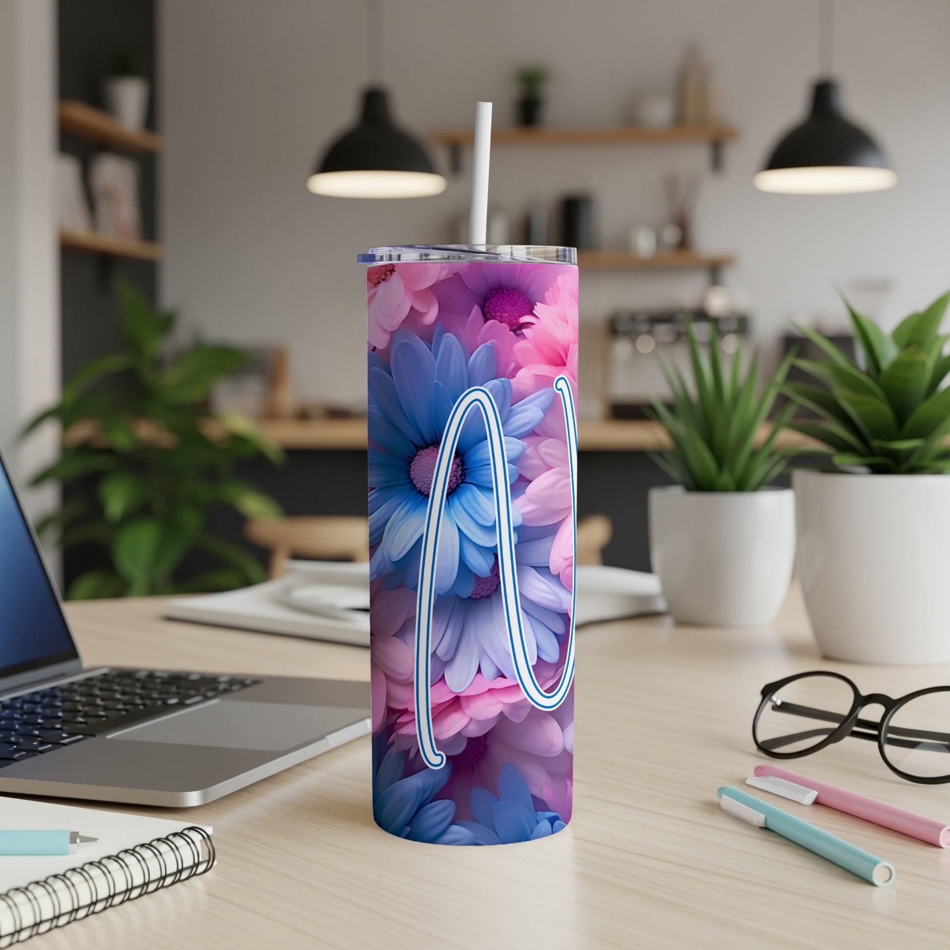 Tall tumbler with a floral pattern and a cursive "M" design.