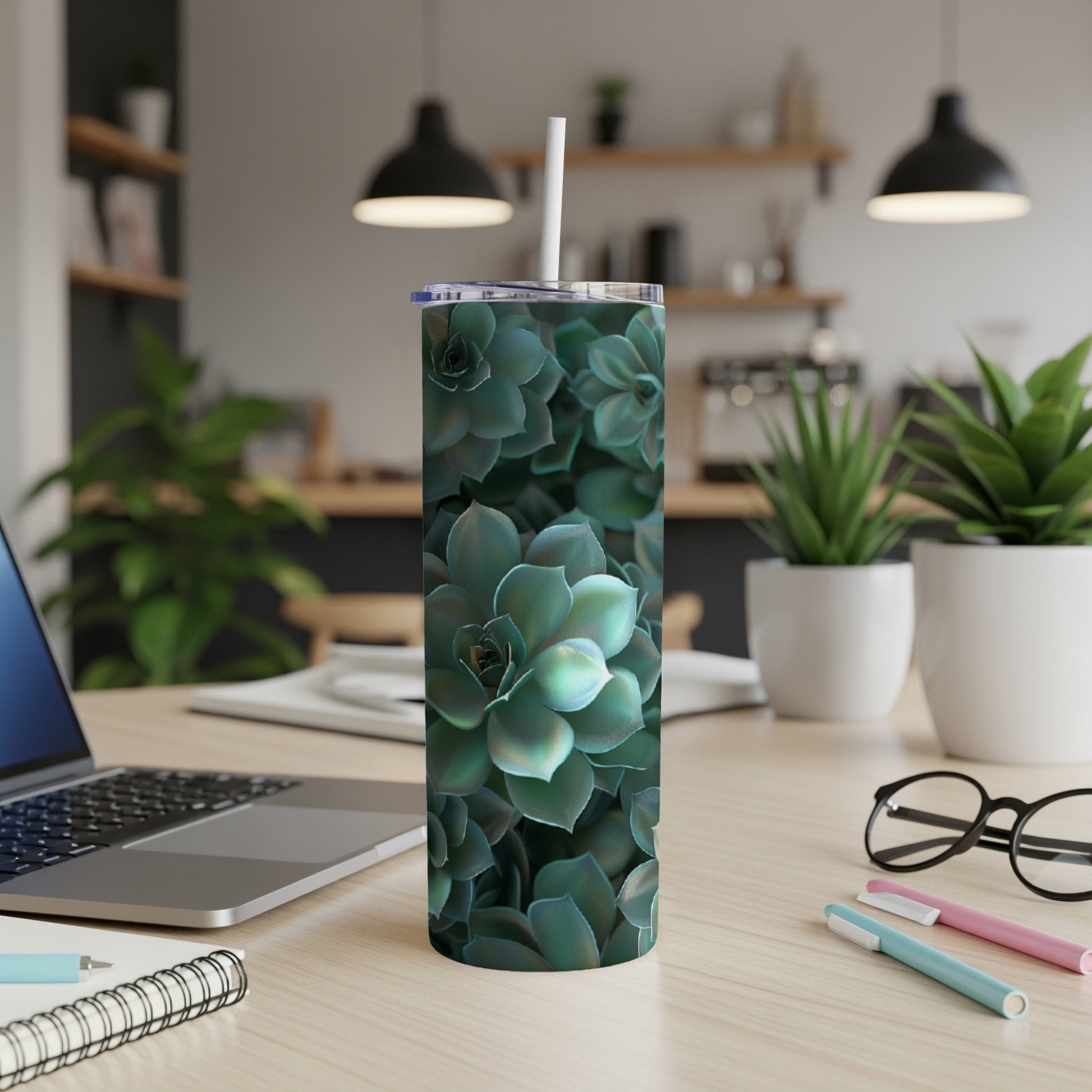 Green succulent pattern on a stainless steel tumbler with a straw.
