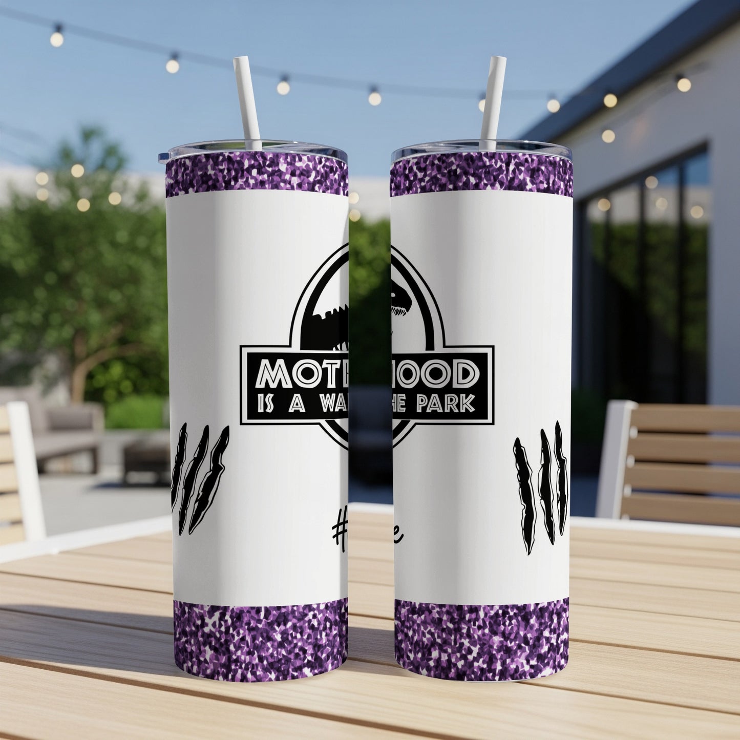 Two white tumblers with purple glitter base, Jurassic Park-style "Motherhood is a walk in the park" logo.