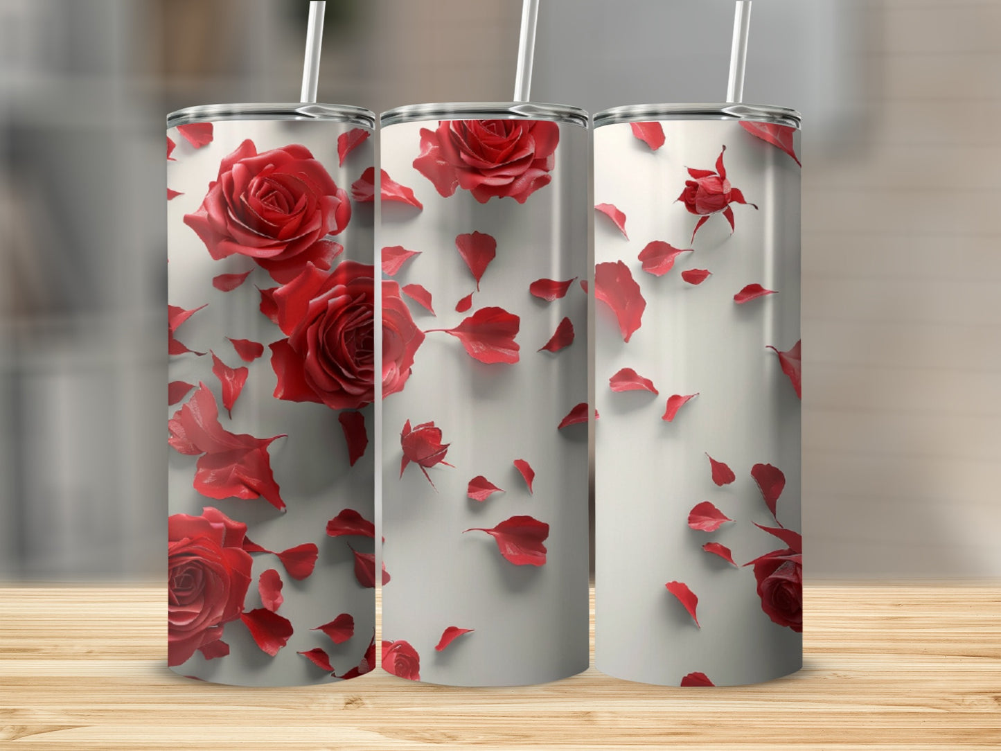 Three tumblers with red roses and rose petals scattered across a white background.