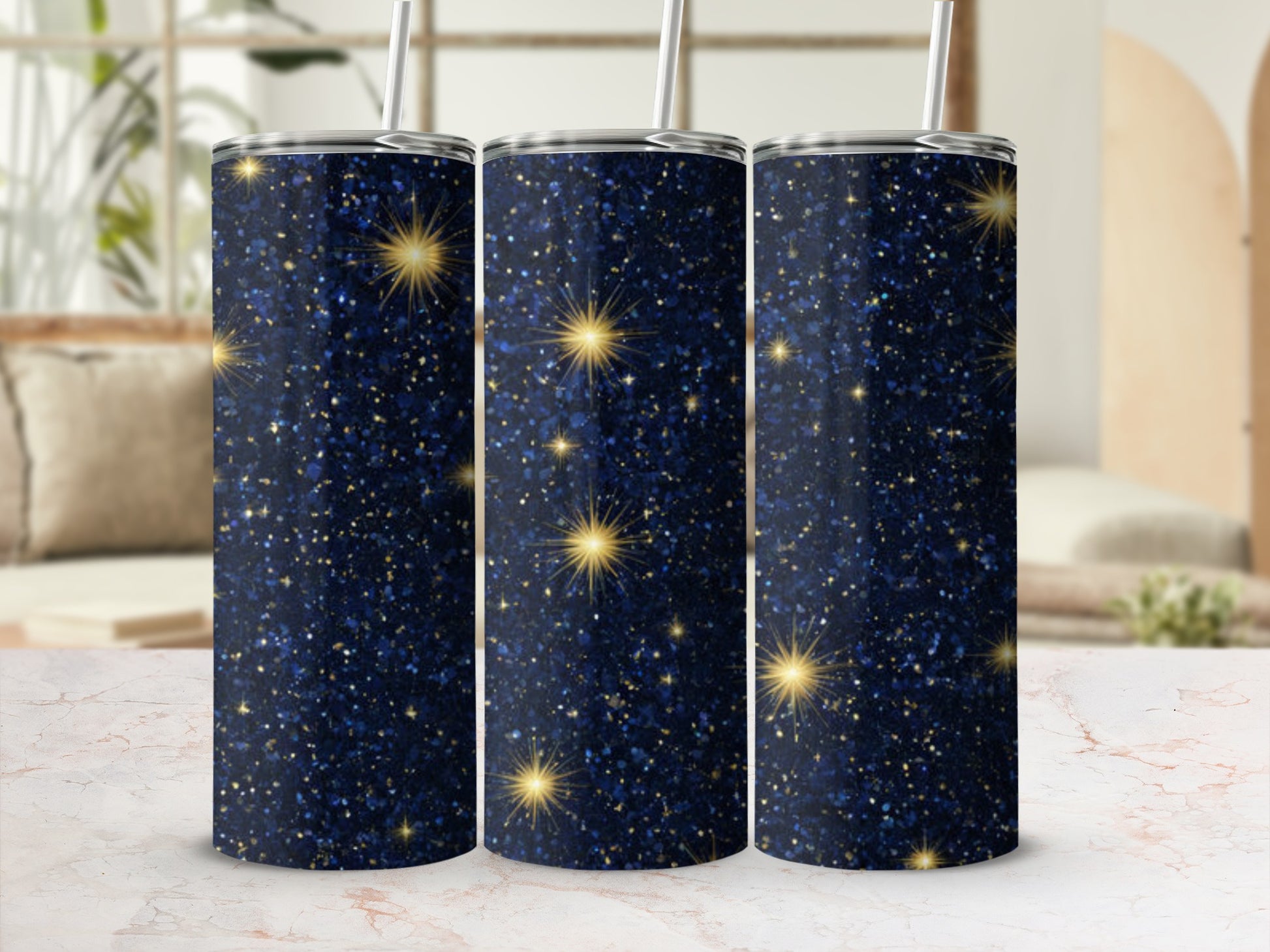 Three dark blue tumblers with gold glitter and starbursts.