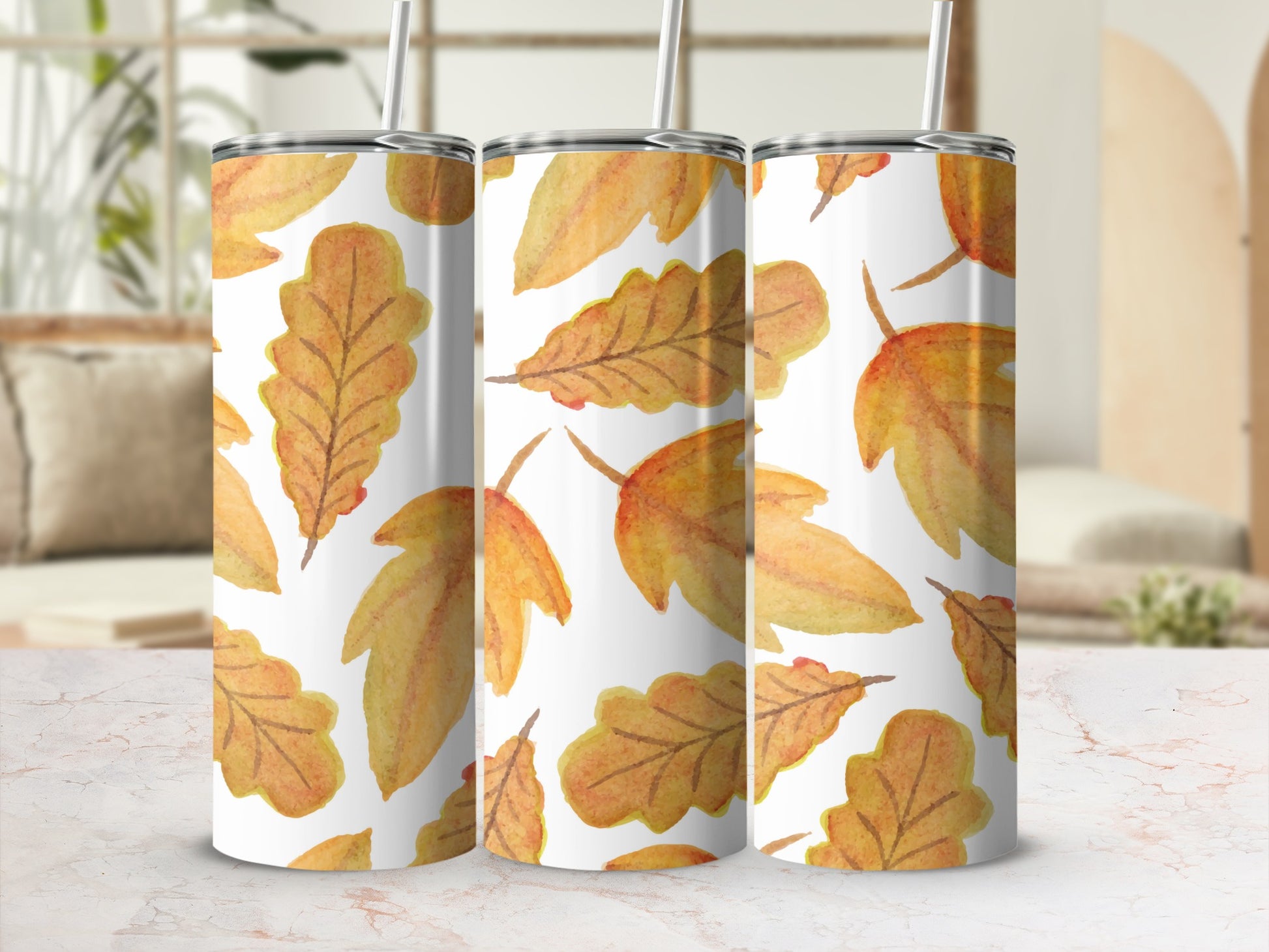 Three tumblers with a watercolor autumn leaf pattern.