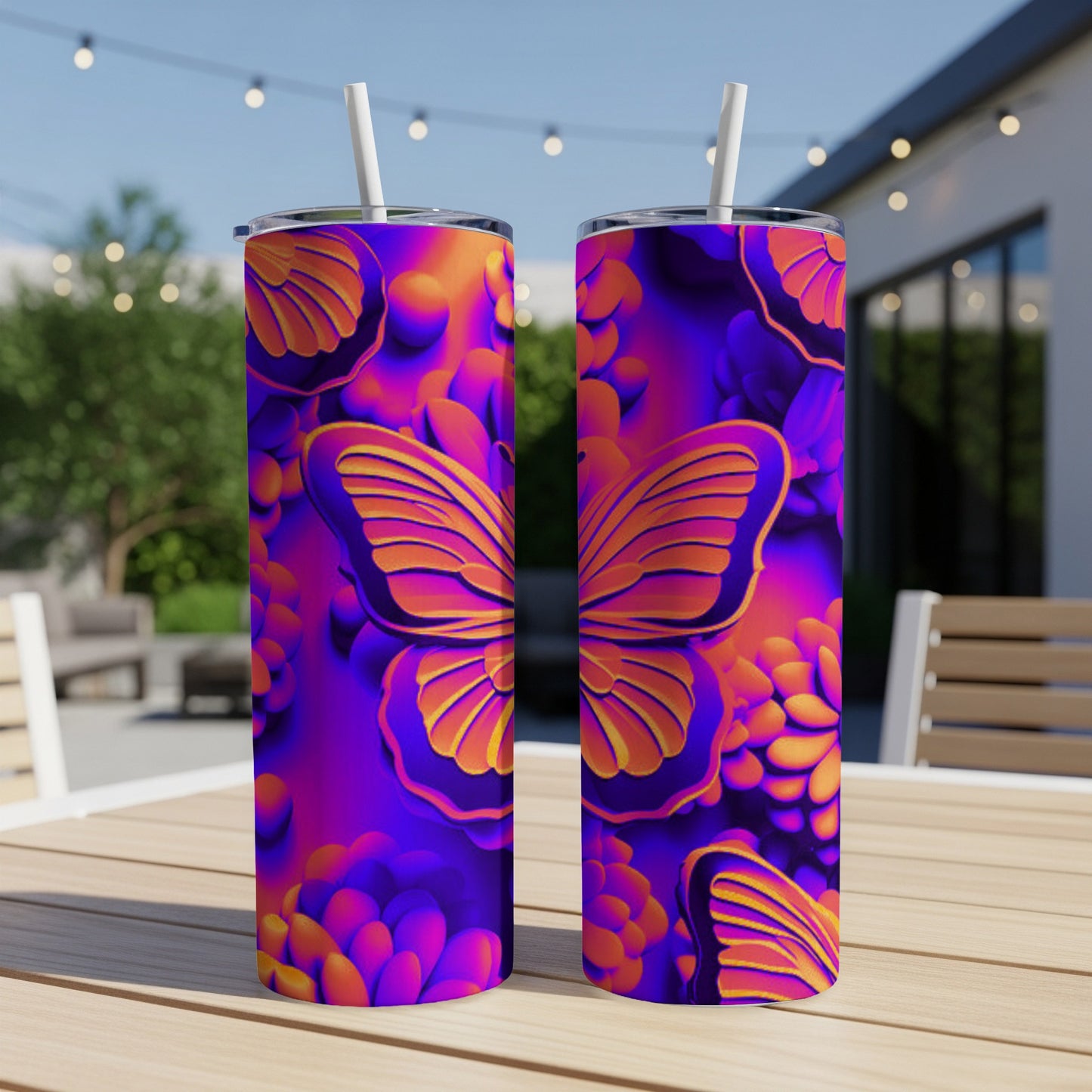Two purple tumblers with butterfly and floral pattern on an outdoor table.