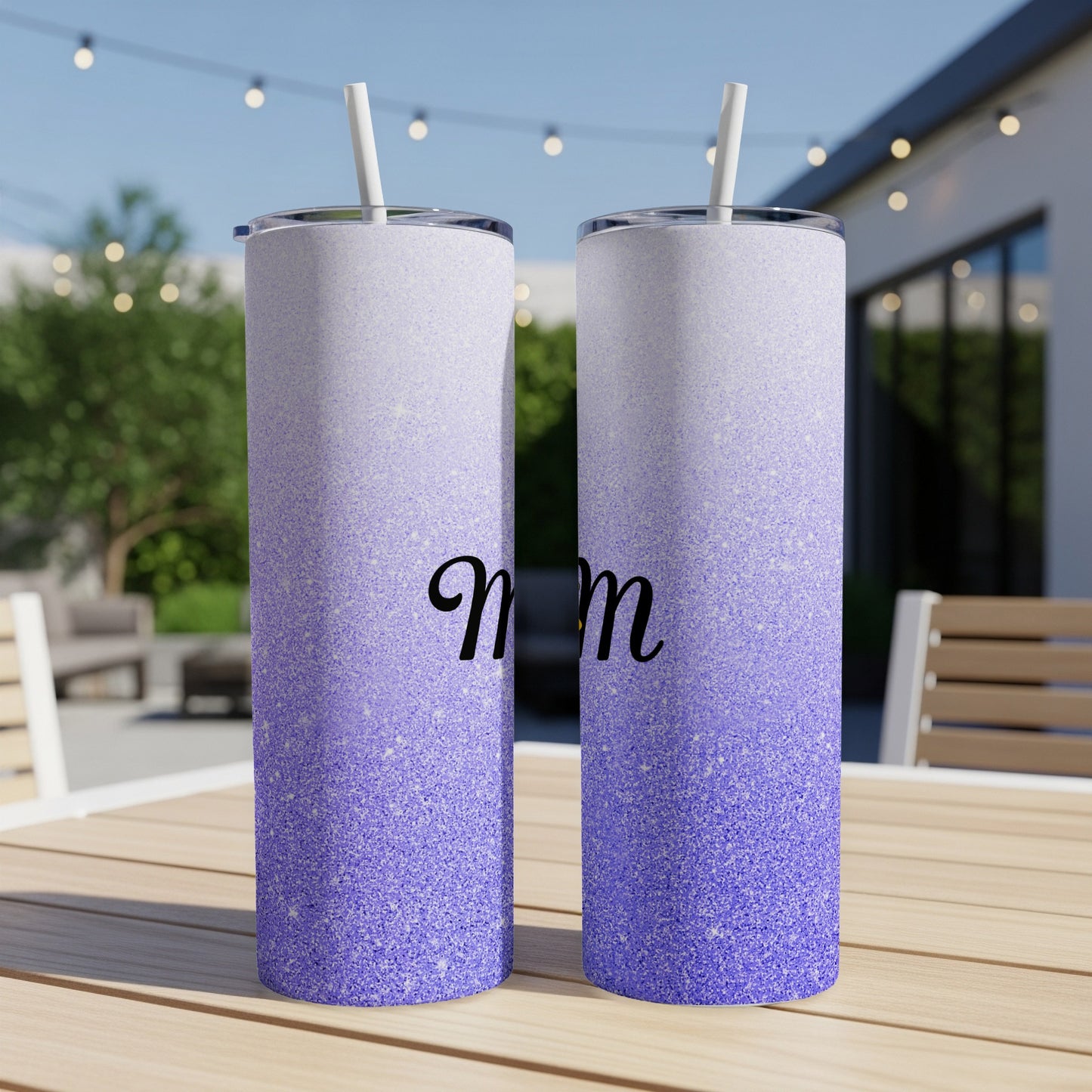 Two purple glitter tumblers with "Mom" text on a table.