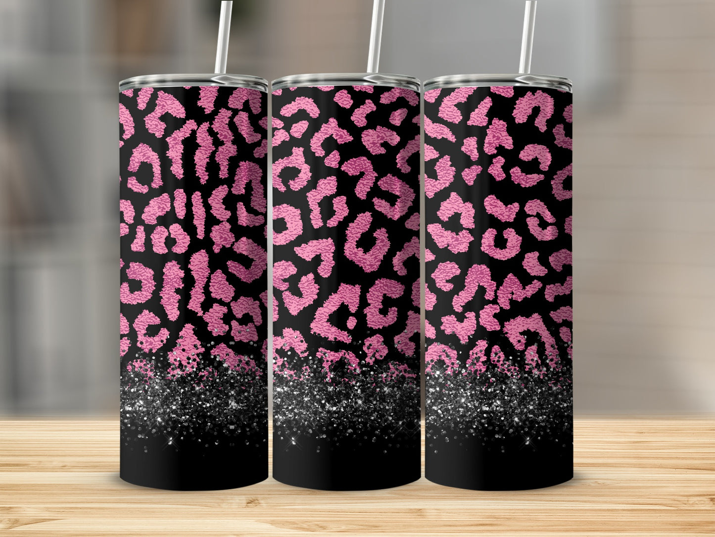 Three tumblers with pink leopard print and a glittery black bottom.