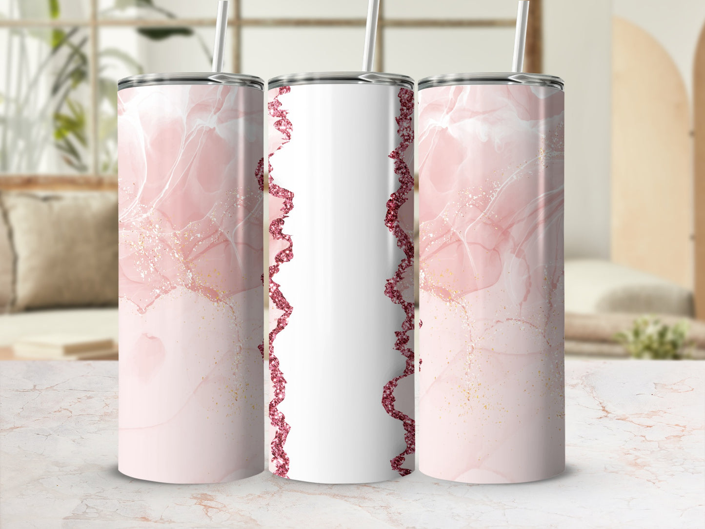 Three tall tumblers with pink marble and glitter designs.