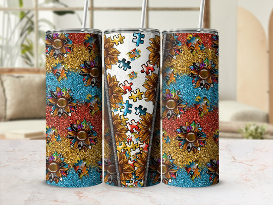 Three tumblers with sunflower and glitter puzzle piece designs.