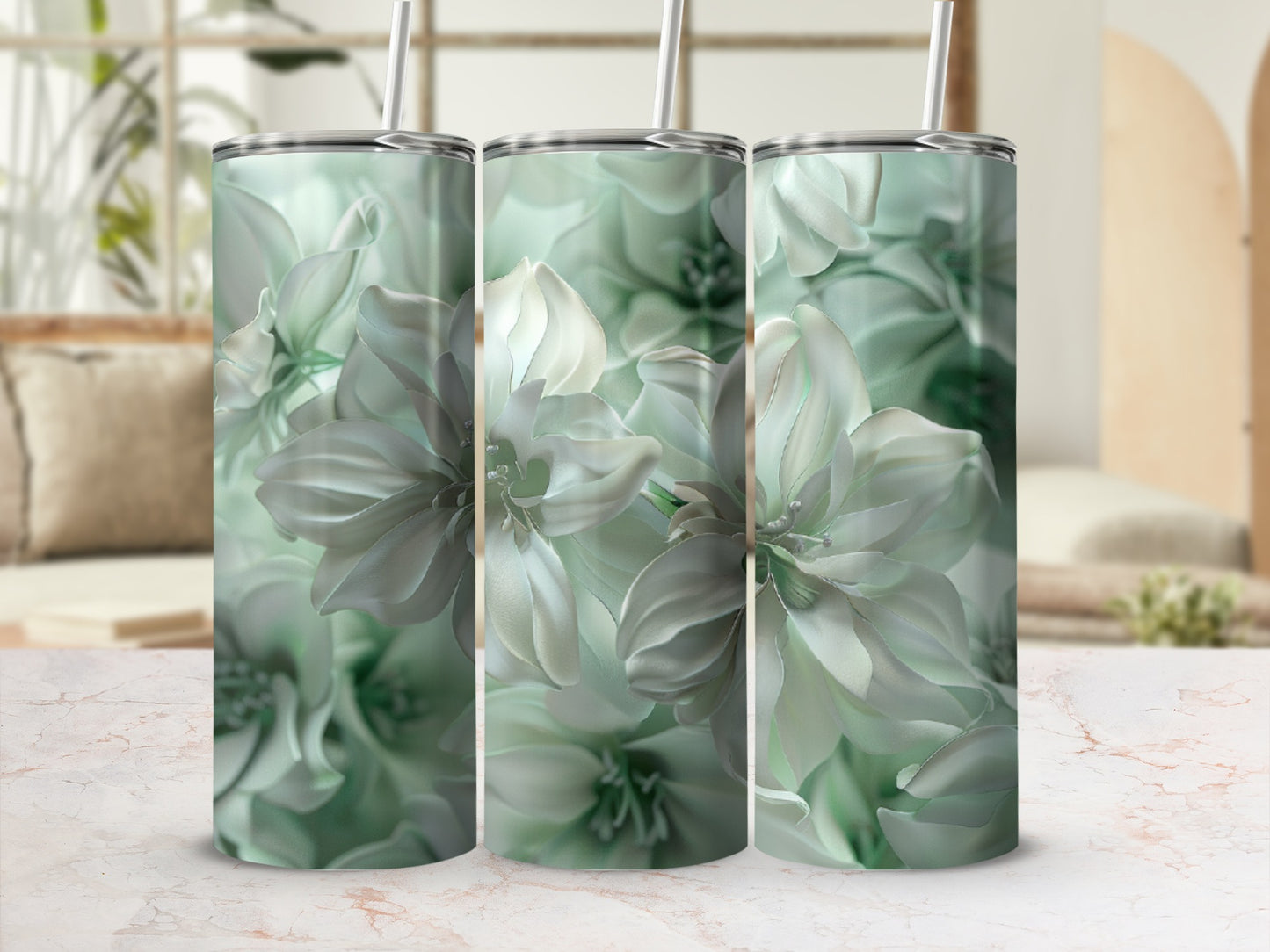 Three tumblers with a pale green floral design on a patterned surface.