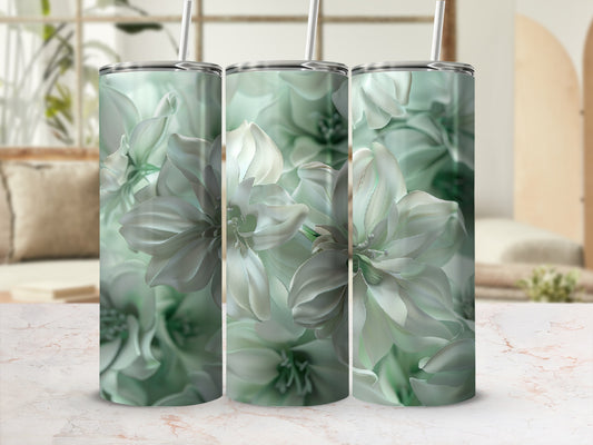 Three tumblers with a pale green floral design on a patterned surface.